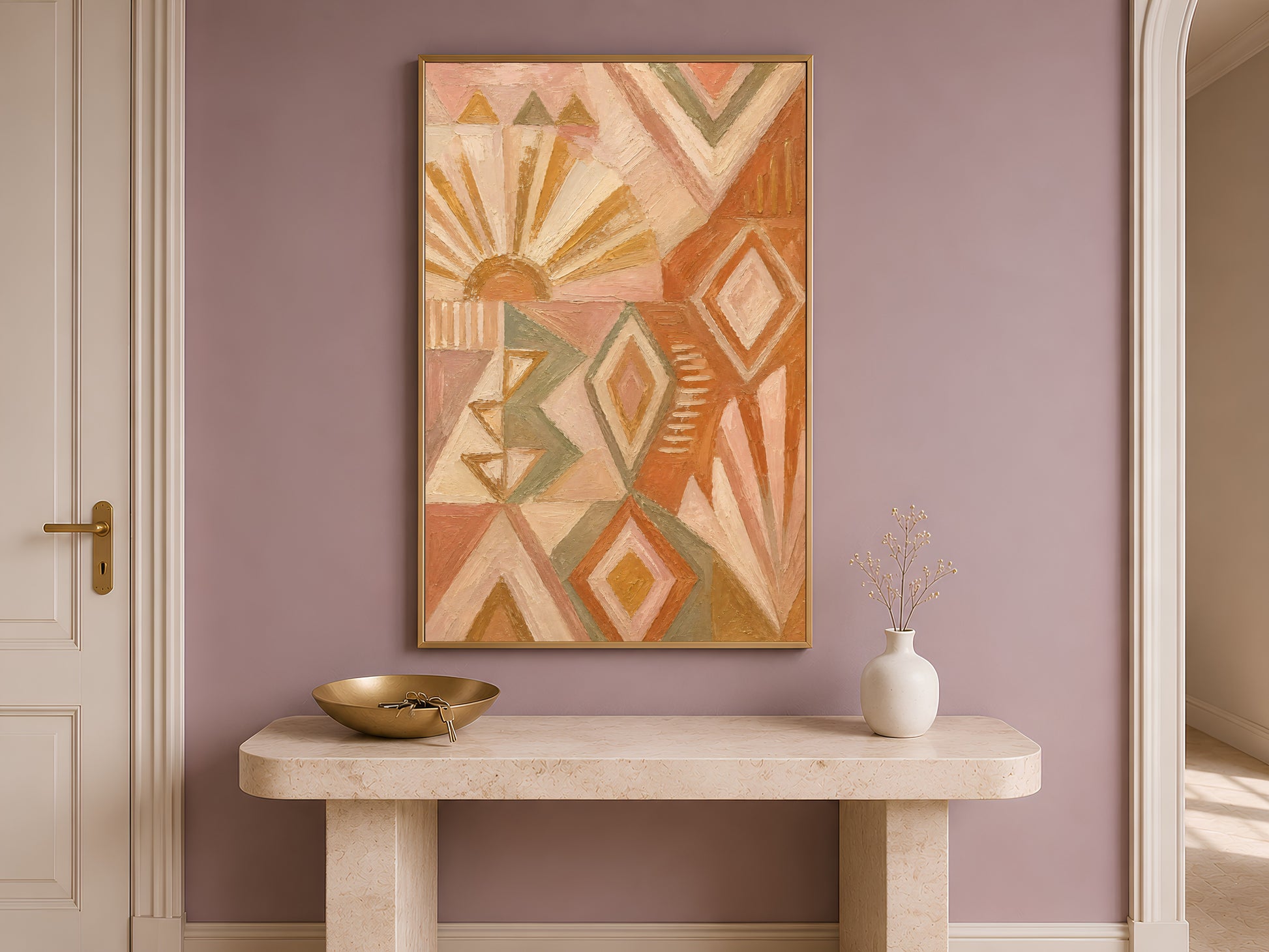 Boho geometric wall art framed above a wooden entryway console table with a small bowl and vase
