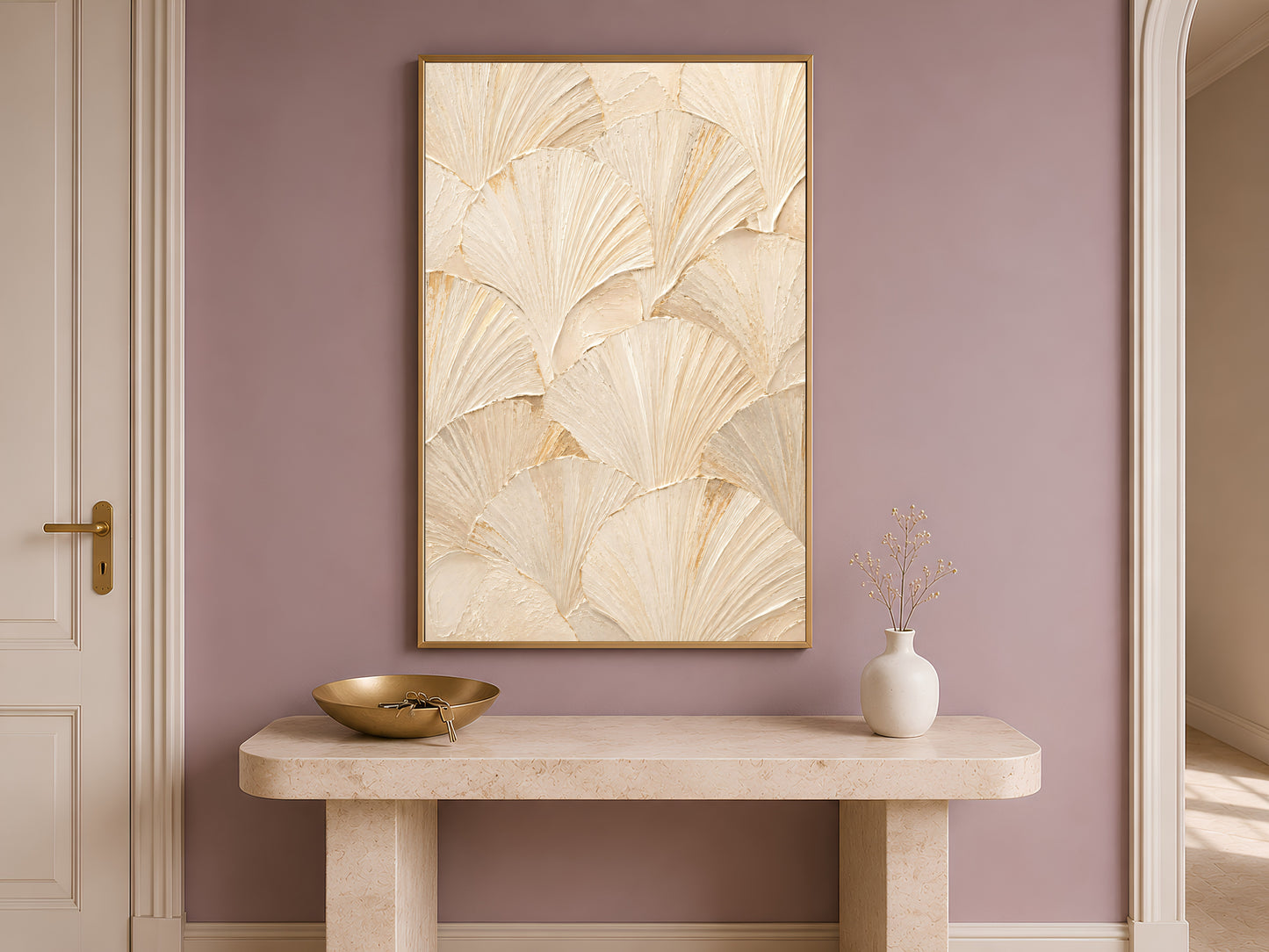 Ginkgo leaf print framed in gold hanging above a narrow wooden console table.
