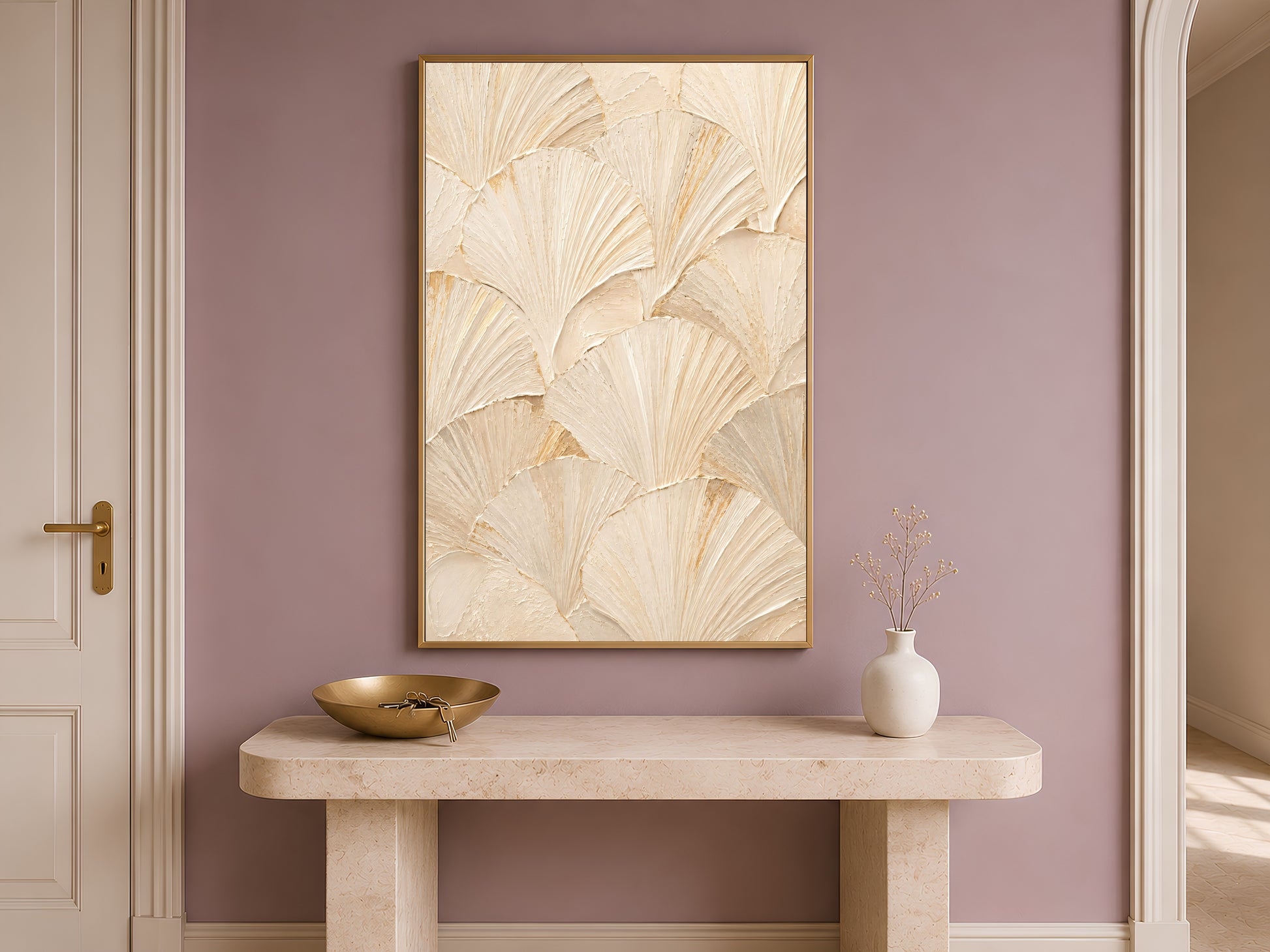 Ginkgo leaf print framed in gold hanging above a narrow wooden console table.
