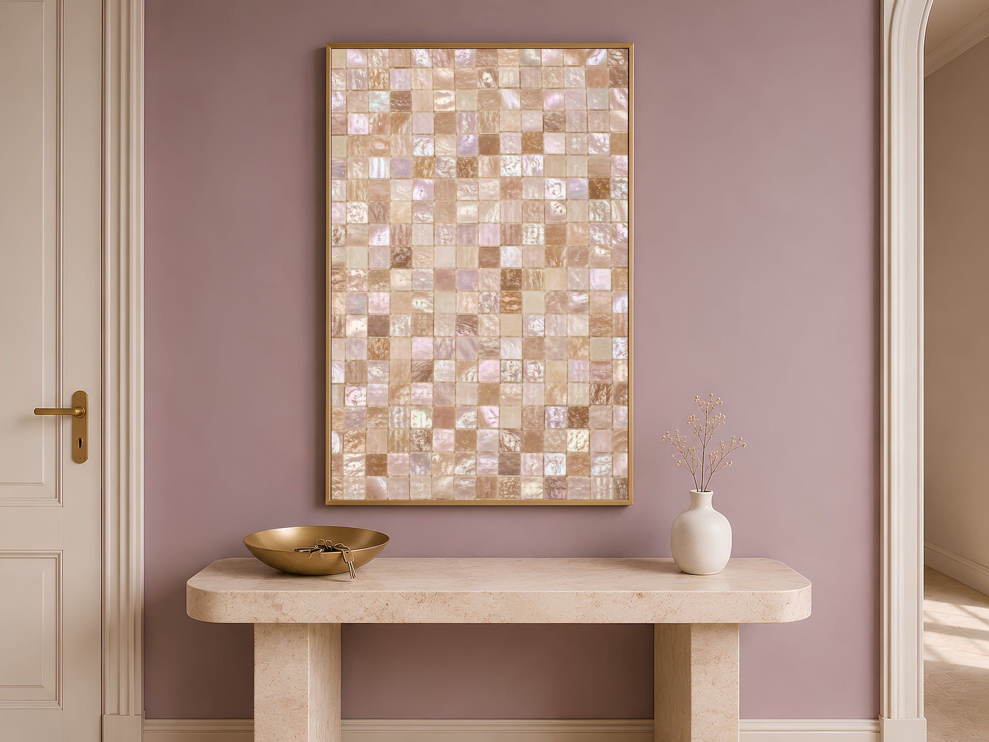 Mother of pearl mosaic wall art print in a gold frame above a console table with a bowl and vase against a mauve wall.
