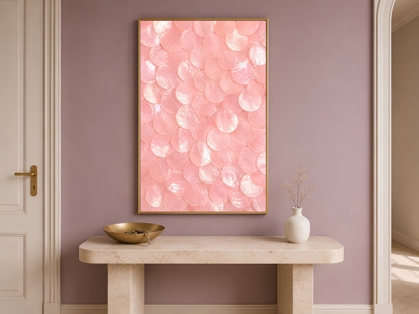 Pink capiz shell dot print in a gold frame hung above a console table in a warm-toned entryway.