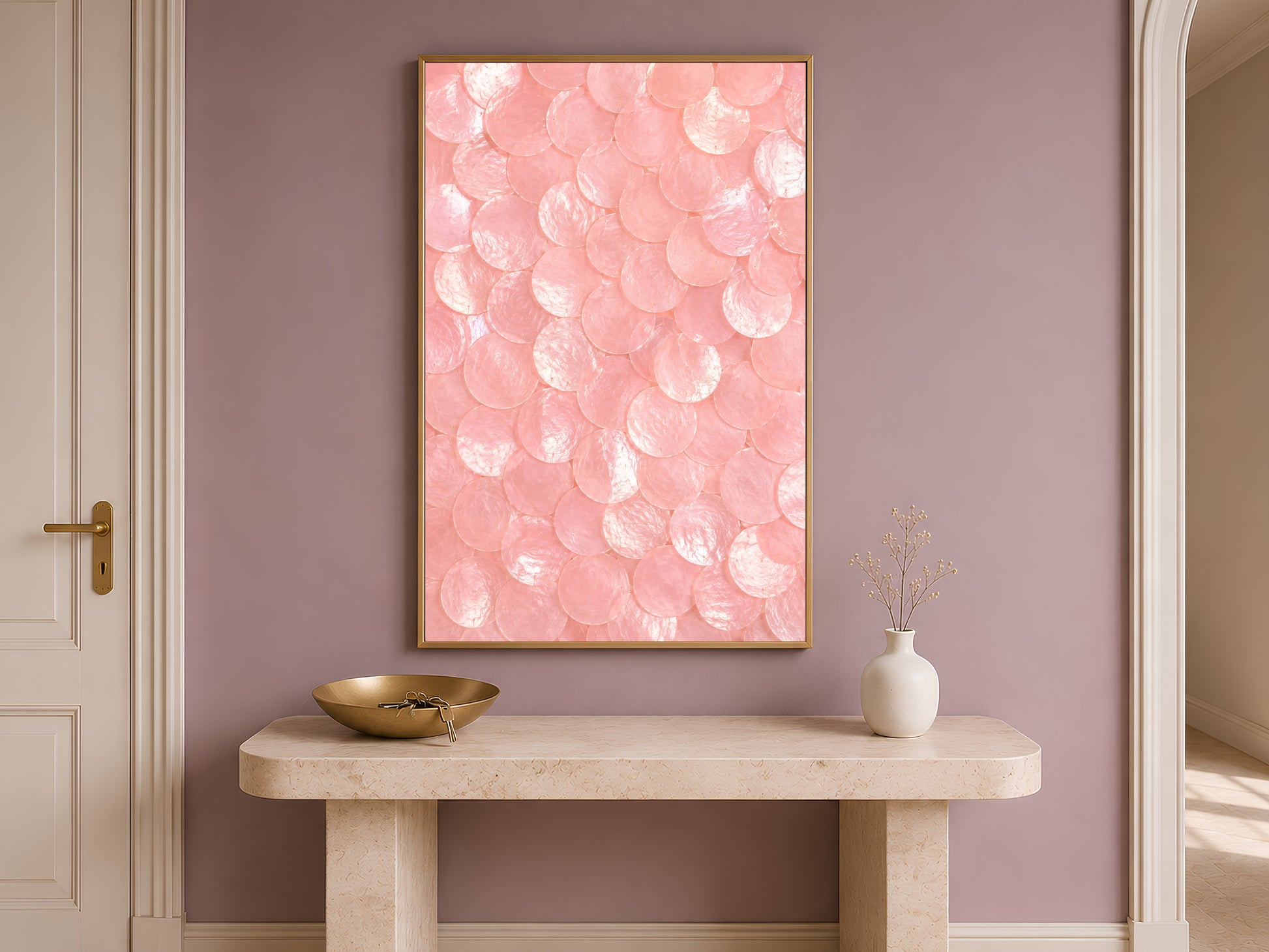 Pink capiz shell dot print in a gold frame hung above a console table in a warm-toned entryway.