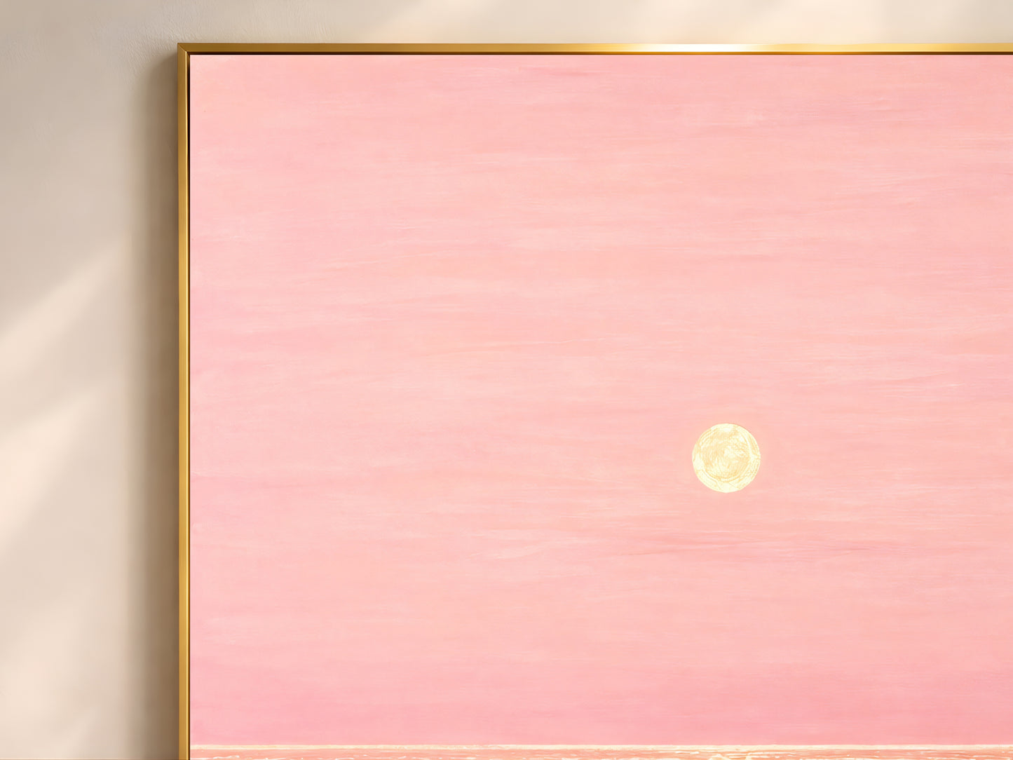 Close-up of pink and gold impasto ocean sunset painting texture in thin gold frame
