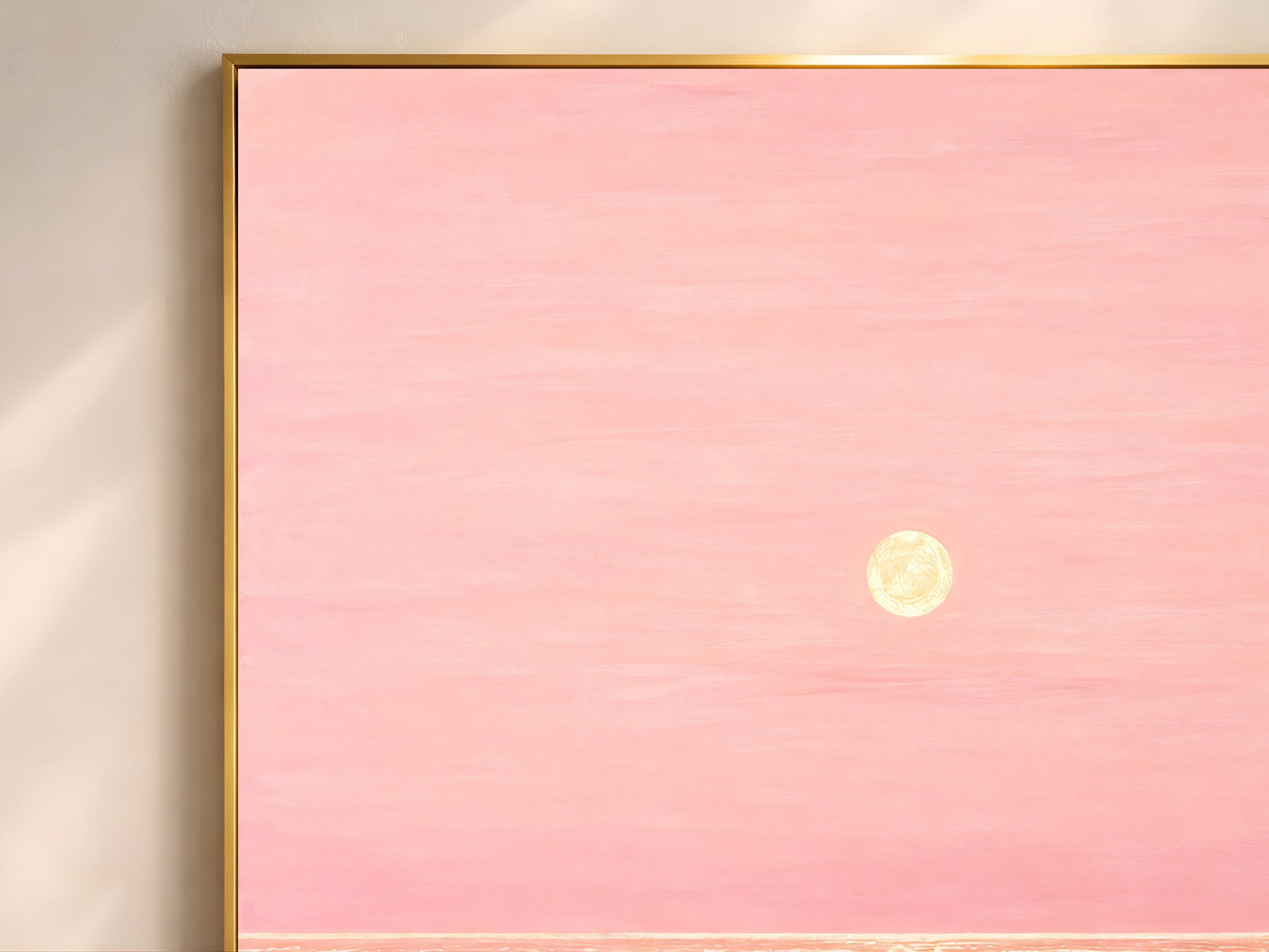 Close-up of pink and gold impasto ocean sunset painting texture in thin gold frame
