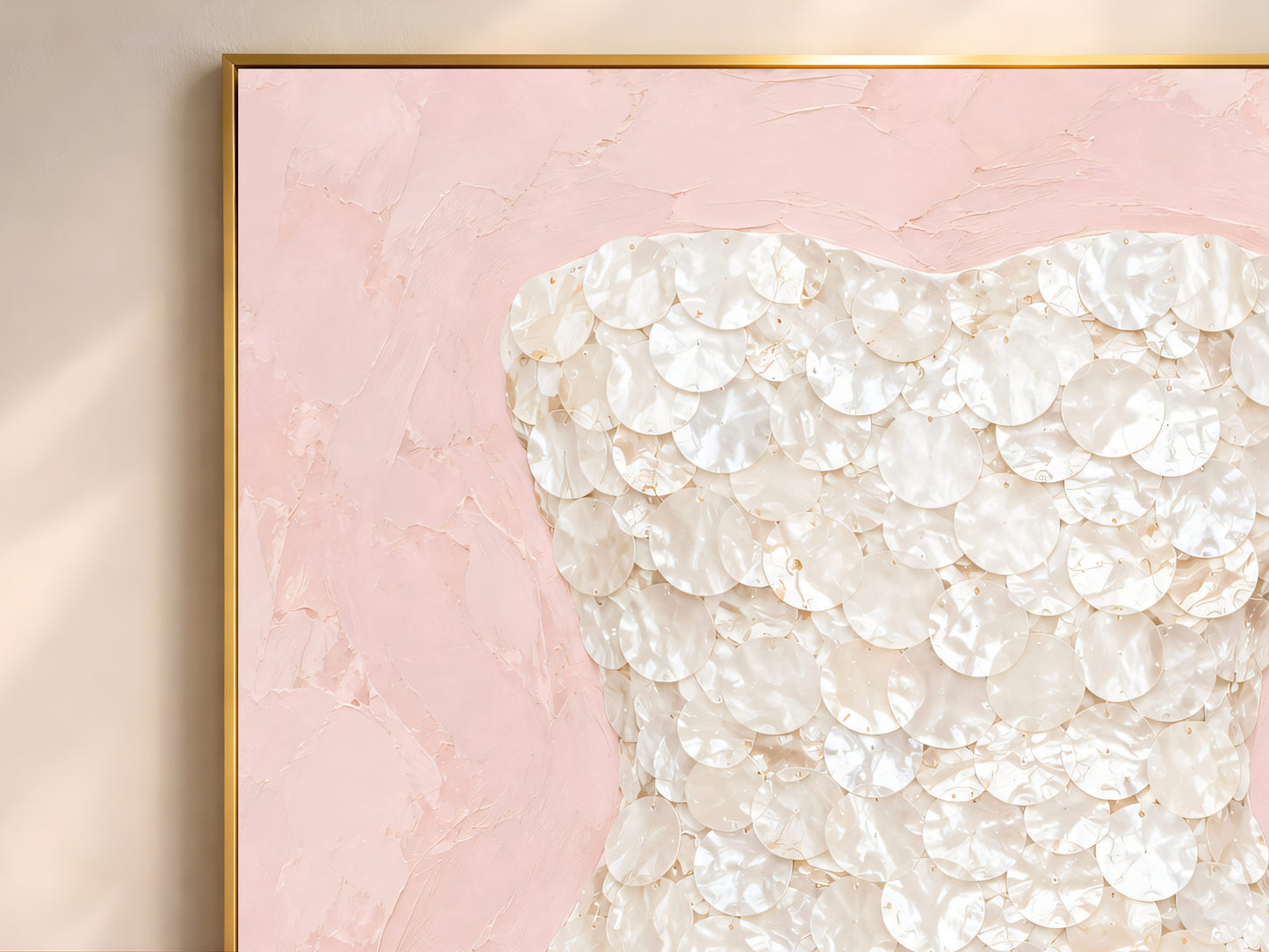 Blush pink mother of pearl wall art framed in gold, styled above a cream sofa in a bright living room.
