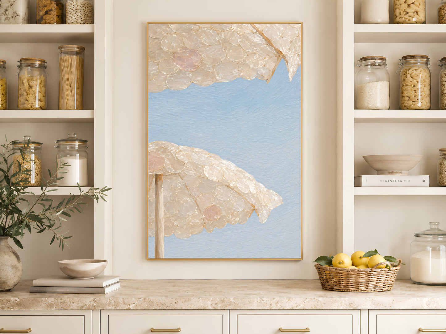 Capiz shell beach umbrella print framed beside open kitchen pantry shelving with jars
