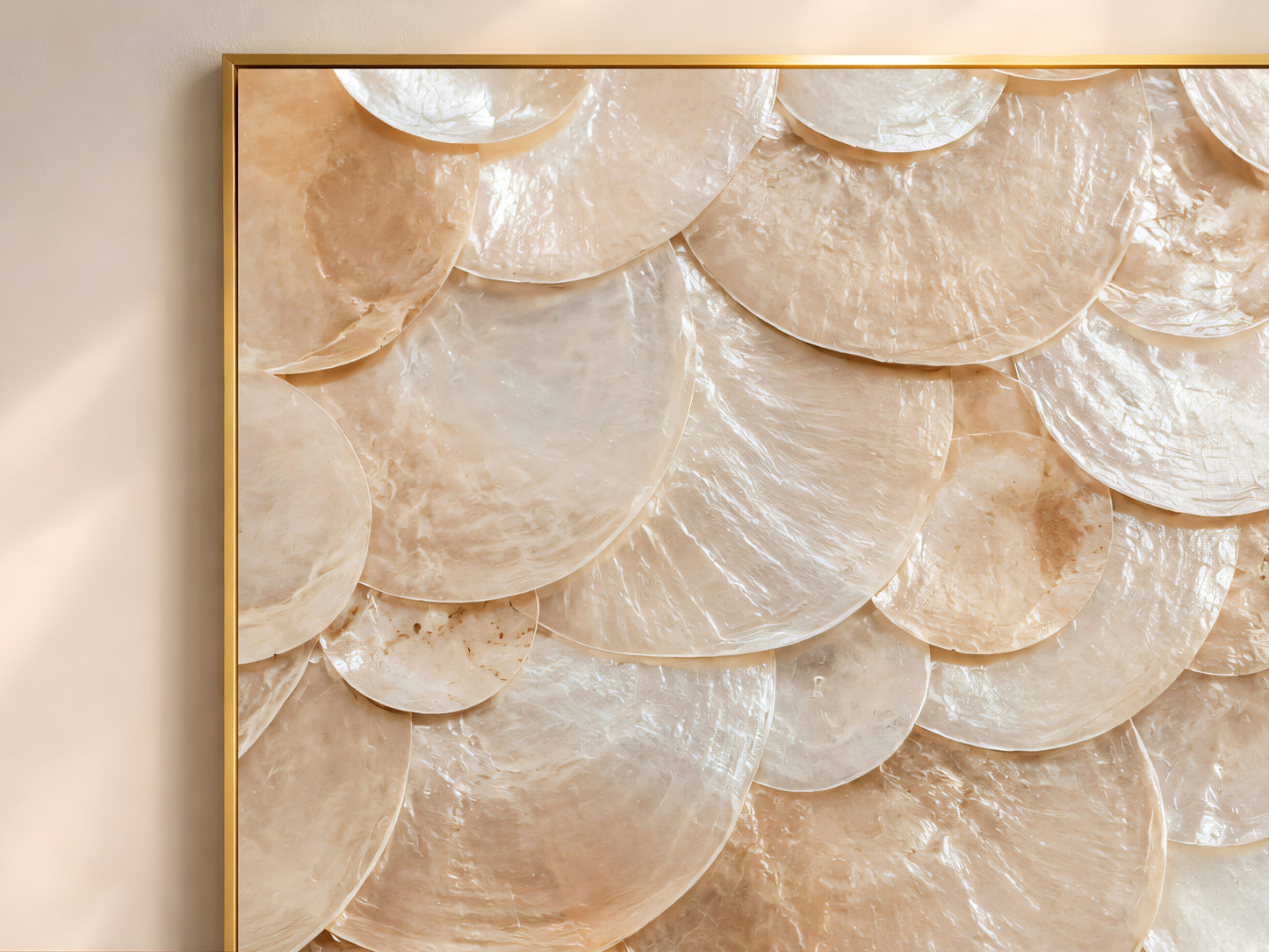 Close-up of the amber and caramel capiz shell mosaic print showing the layered scalloped texture in a thin gold frame.