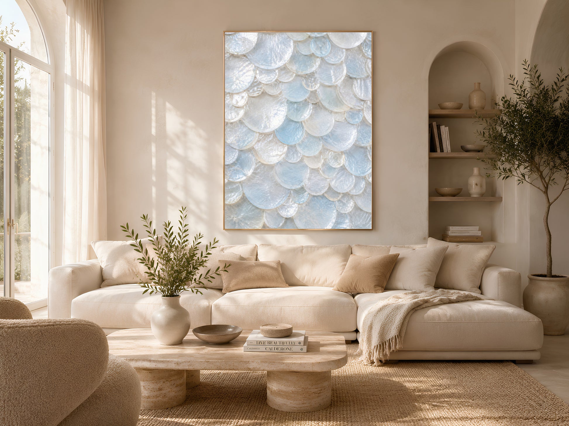 Bright neutral living room with a slipcovered sectional, coffee table styling, and a framed aqua shell print on the wall.