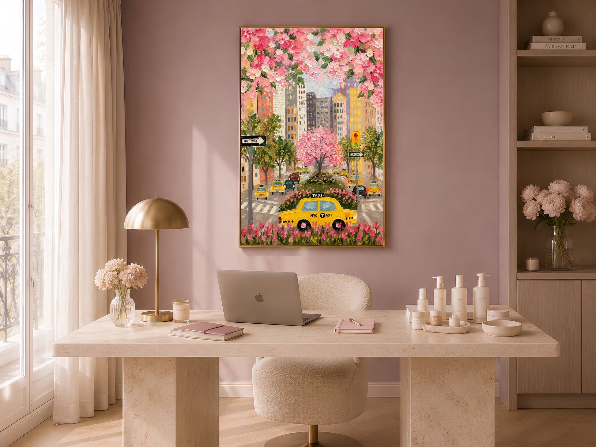 NYC taxi cherry blossom print in gold frame in warm home office above white desk with lamp and candles

