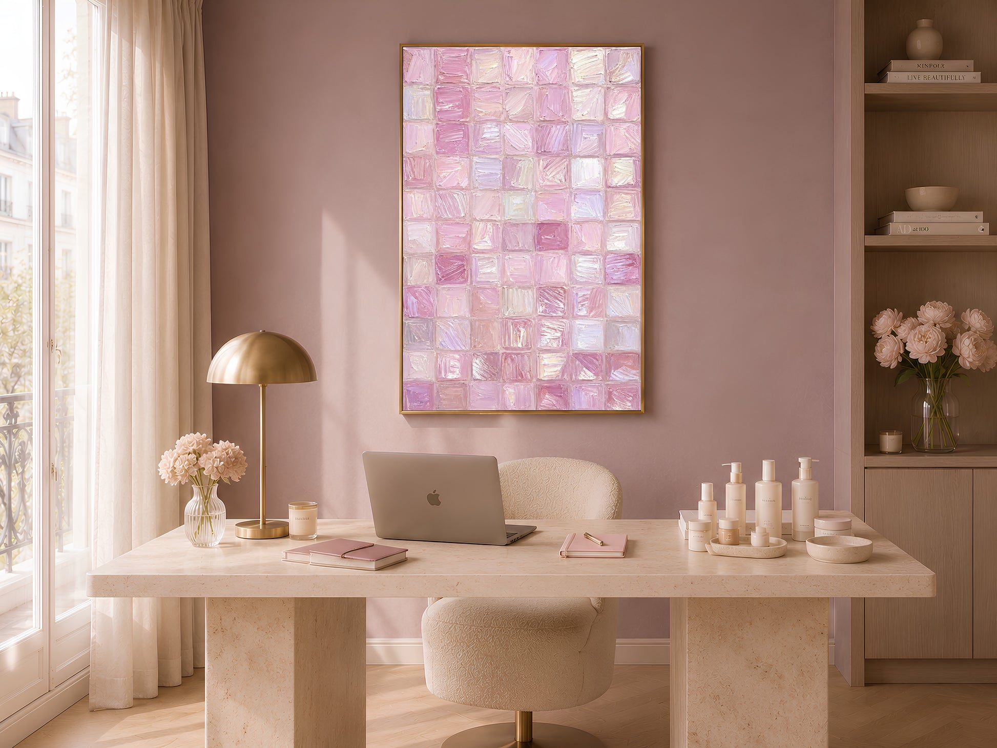 Pink impasto mosaic tile wall art in gold frame in warm home office above white desk with lamp and candles
