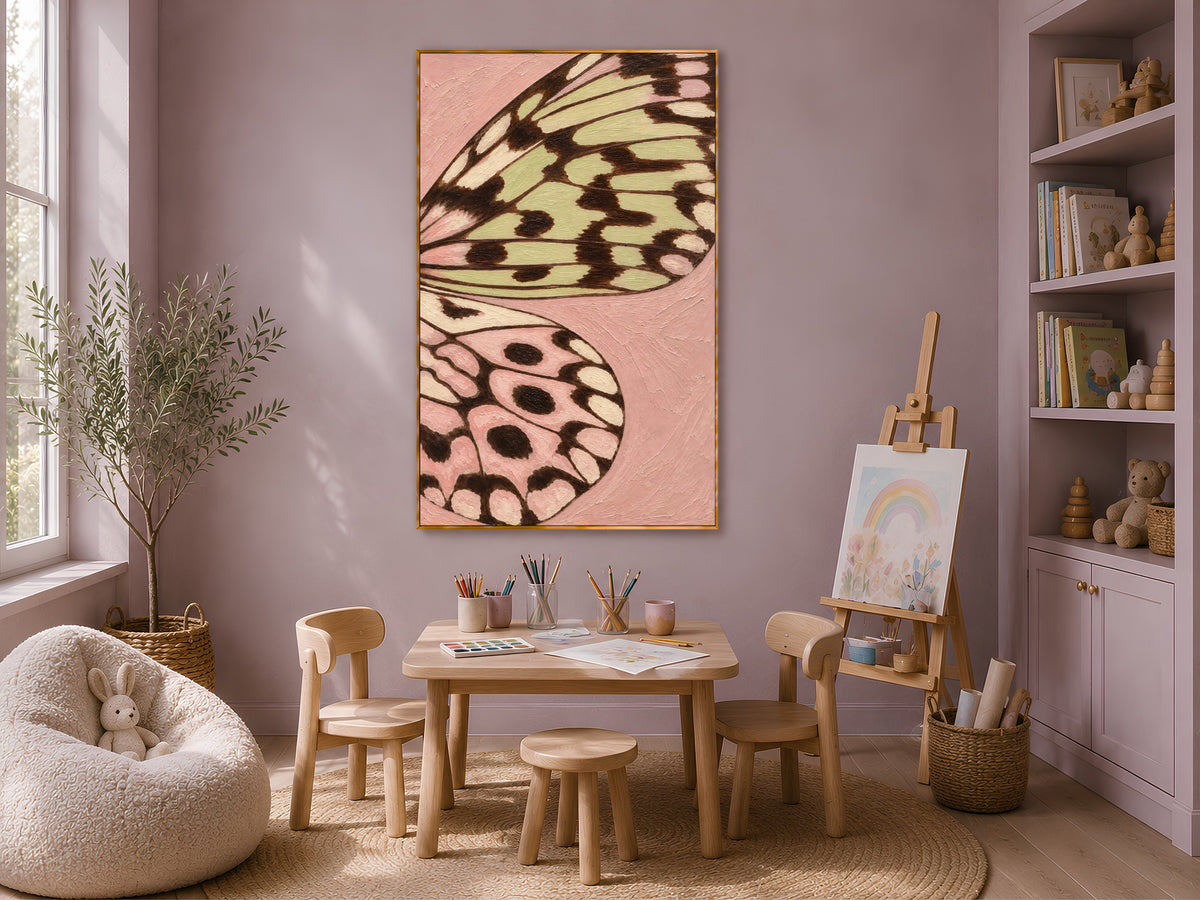 Pink and sage green butterfly wall art framed in a cozy kids playroom with easel and bookshelves