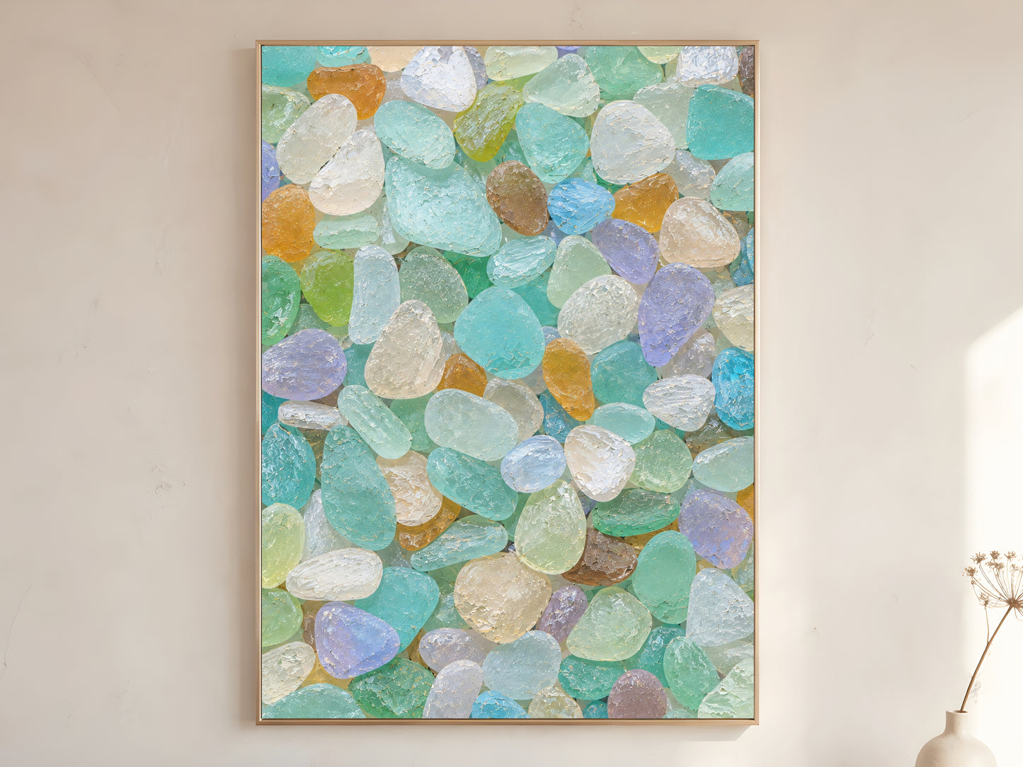 Colorful sea glass wall art in wood frame on warm white wall in minimalist coastal living room with dried botanicals
