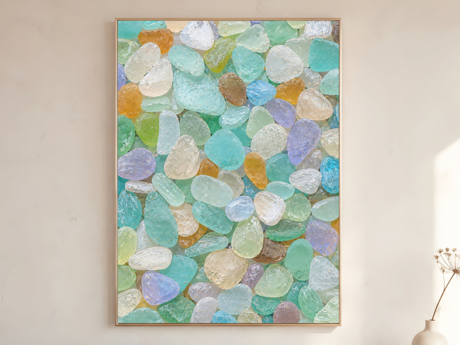 Colorful sea glass wall art in wood frame on warm white wall in minimalist coastal living room with dried botanicals