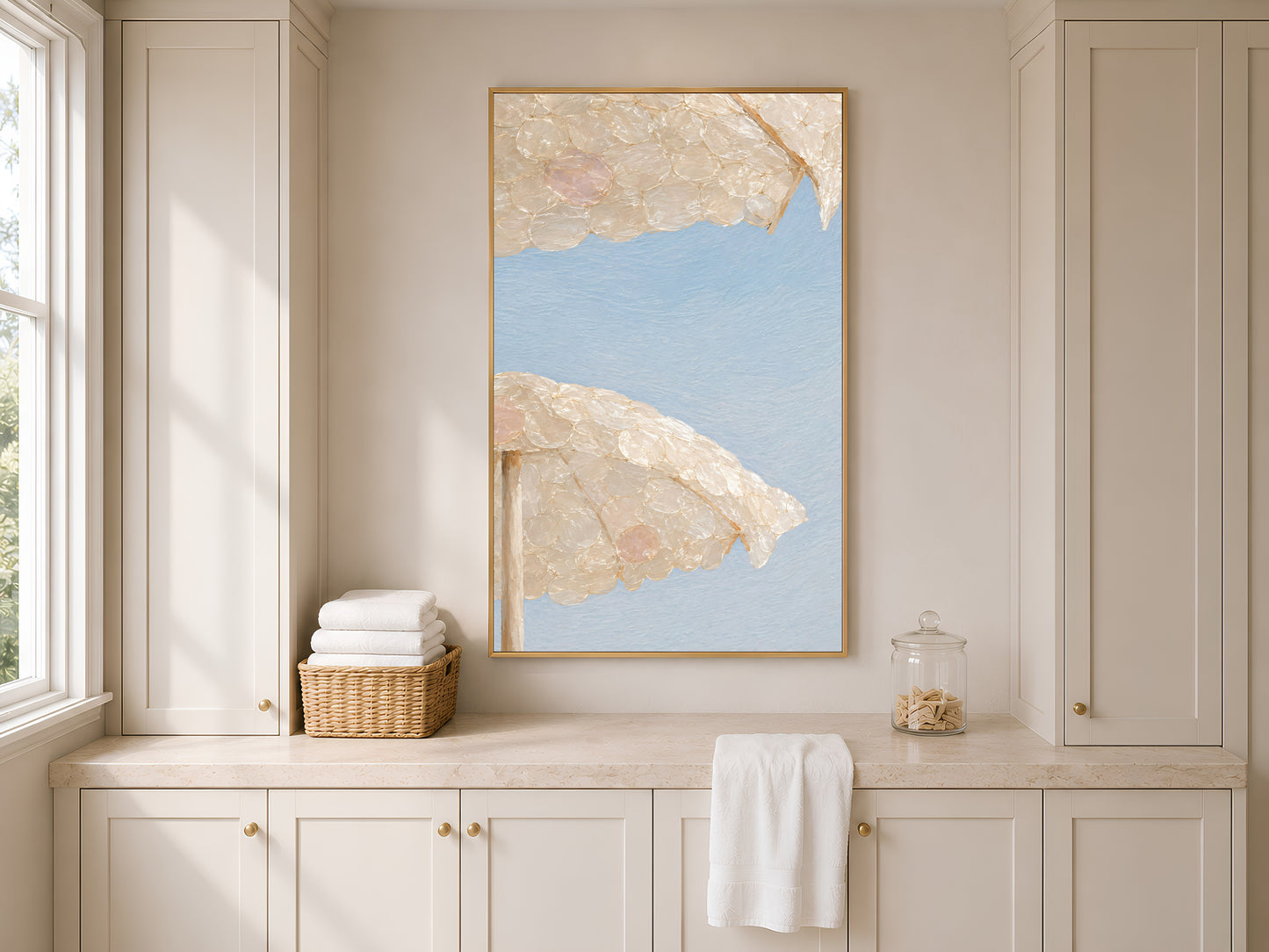 Capiz shell beach umbrella print framed above built-in kitchen cabinetry and a towel rail
