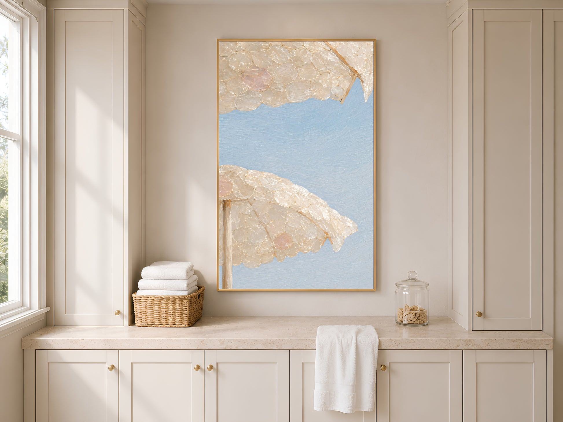 Capiz shell beach umbrella print framed above built-in kitchen cabinetry and a towel rail
