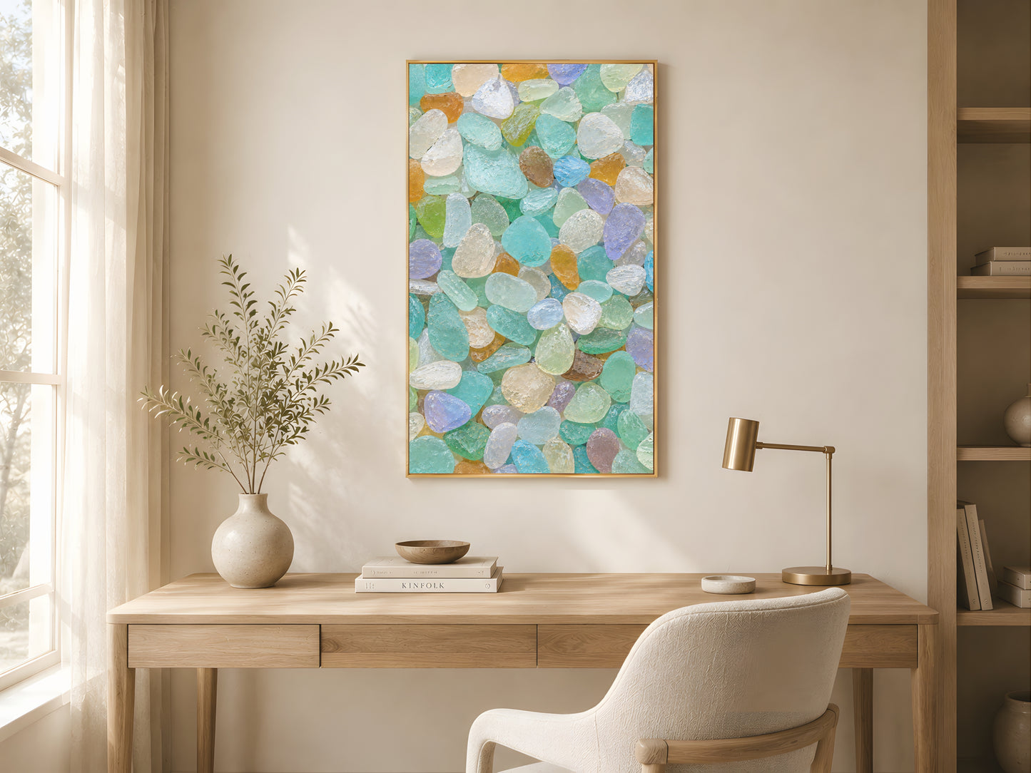 Rainbow beach glass print in gold frame in minimalist home office with oak desk and warm afternoon light