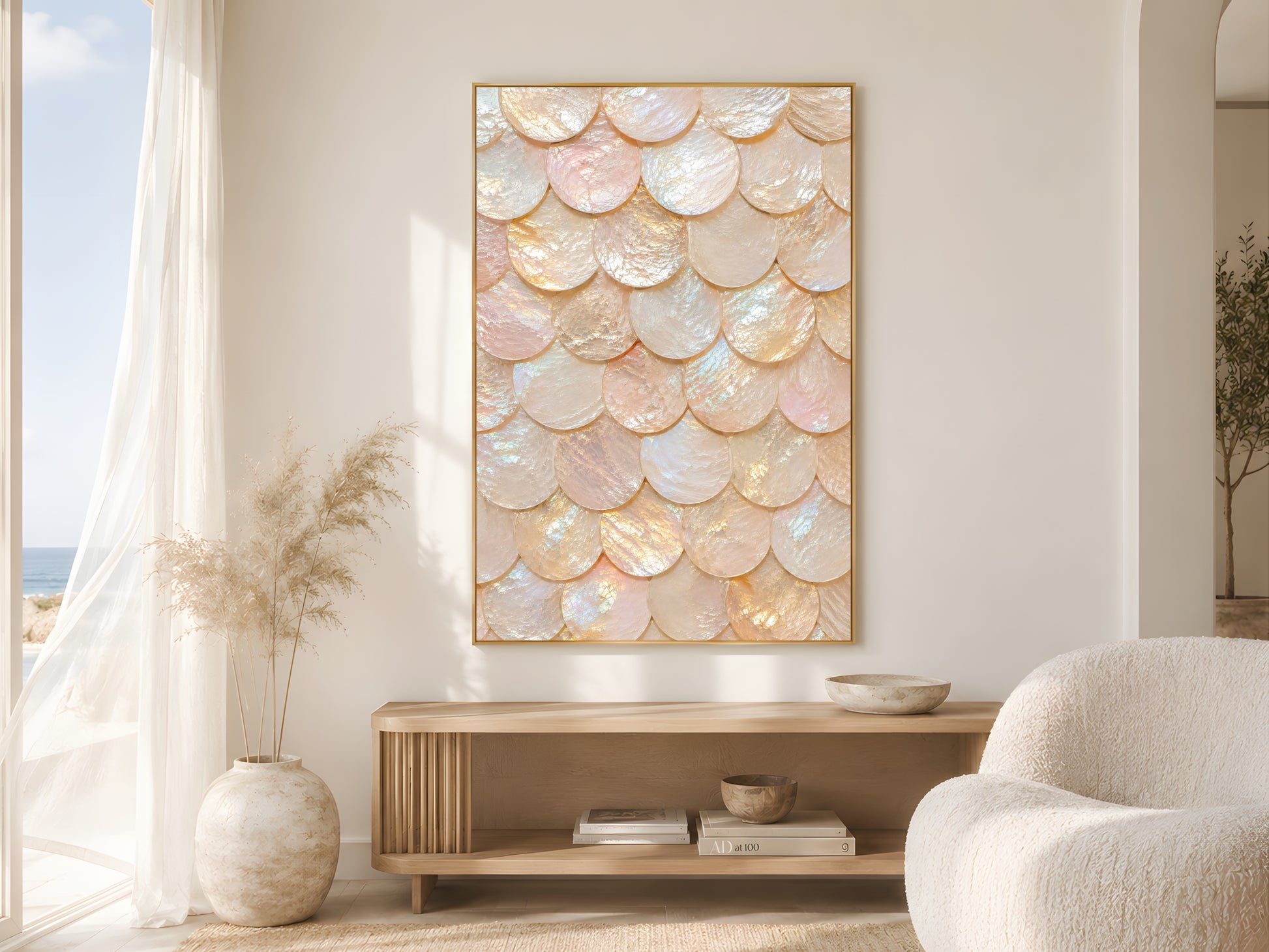 Iridescent capiz shell print in gold frame in bright neutral living room with cream armchair and pampas grass