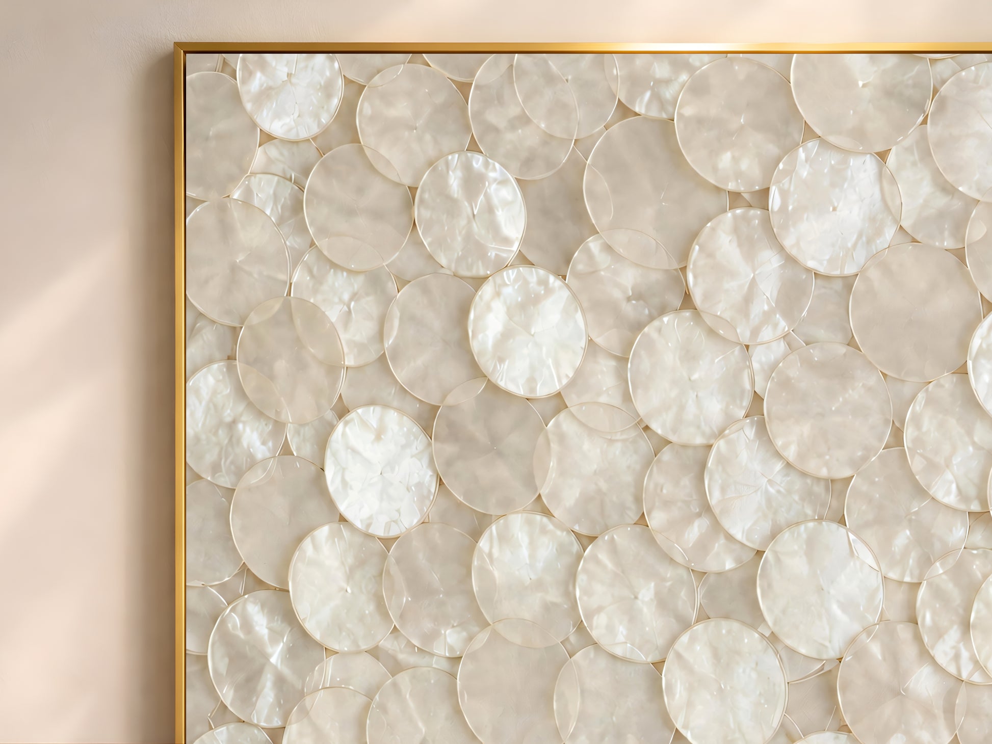 Close-up of a capiz shell mosaic print showing iridescent mother-of-pearl texture in a gold frame

