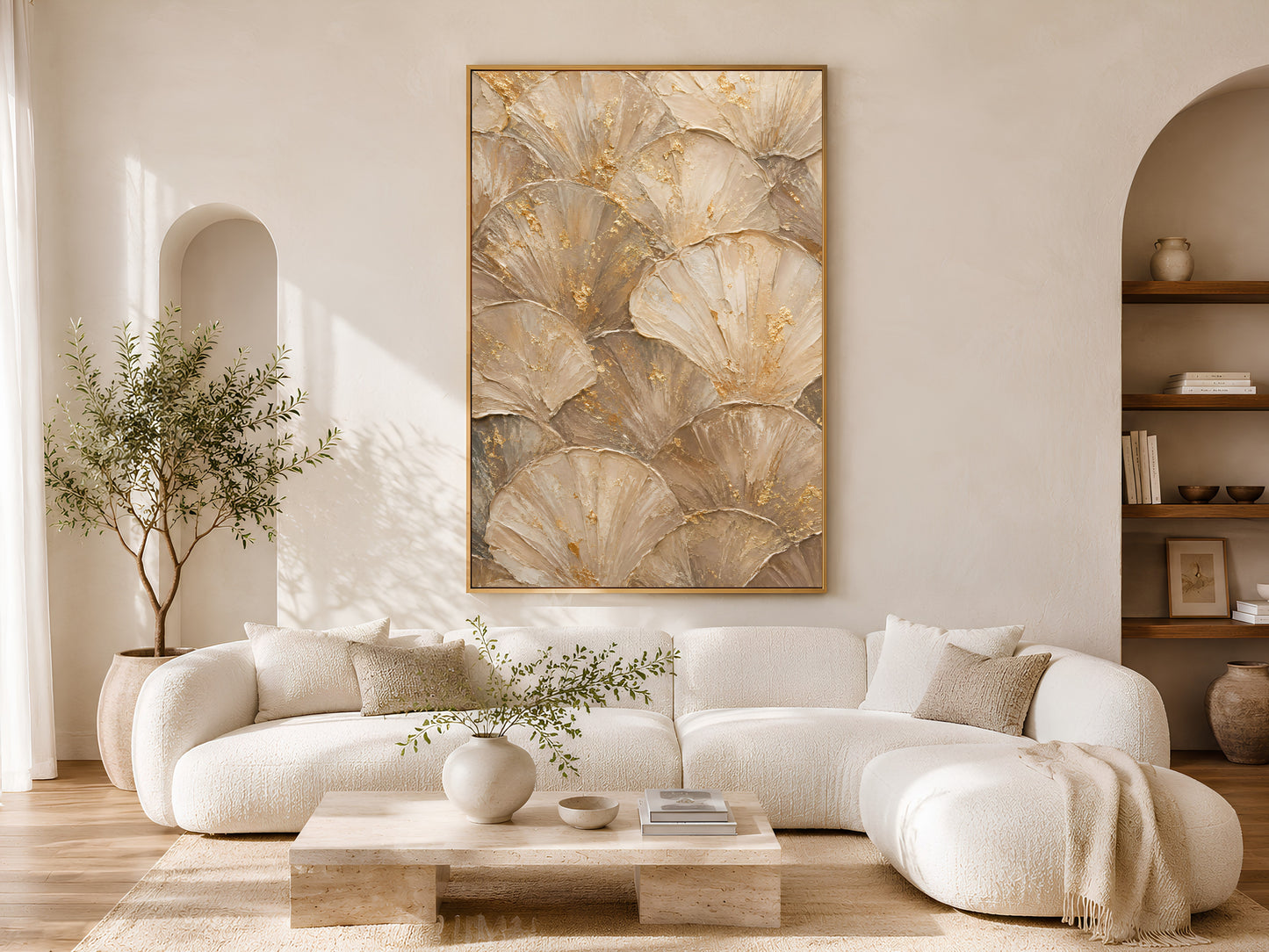 Ginkgo leaf wall art print above cream sofa in bright living room with arched doorway
