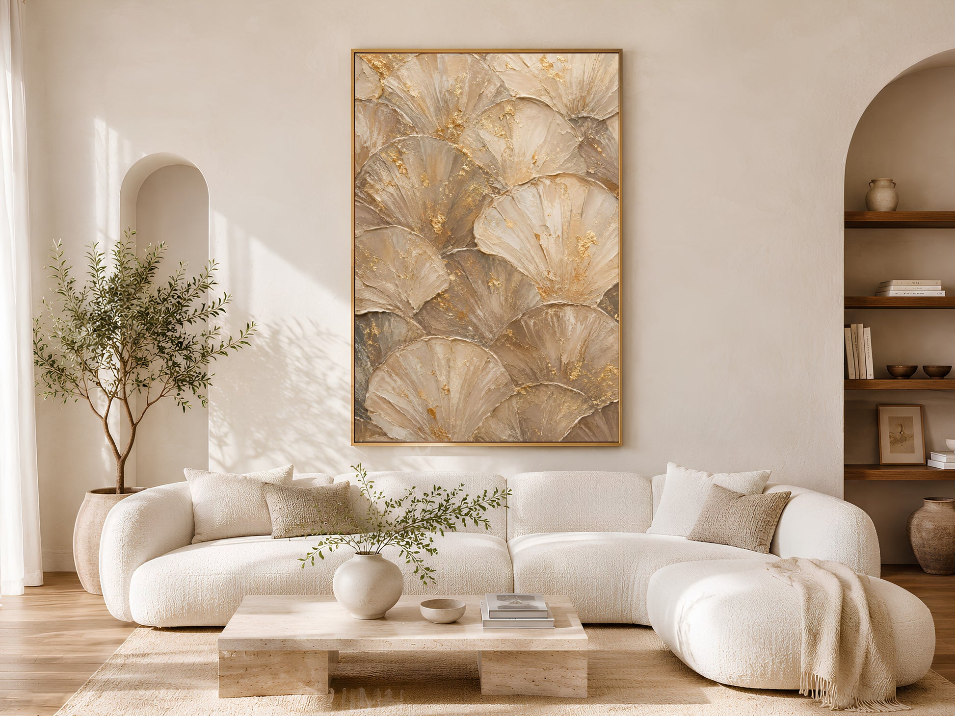 Ginkgo leaf wall art print above cream sofa in bright living room with arched doorway
