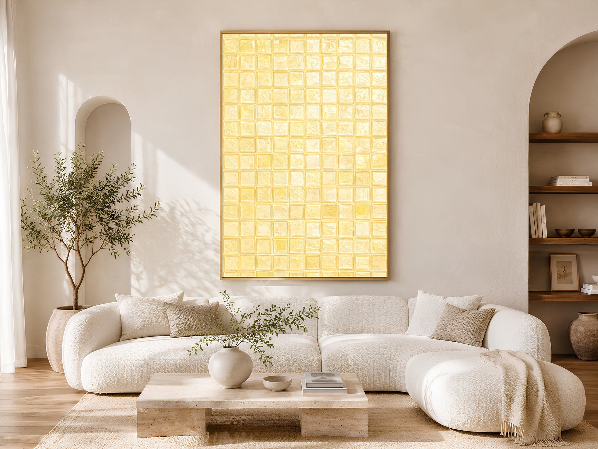 Butter yellow mosaic tile art print in a gold frame in a warm Japandi living room with cream sofa, olive tree, ceramic vessels, and arch window
