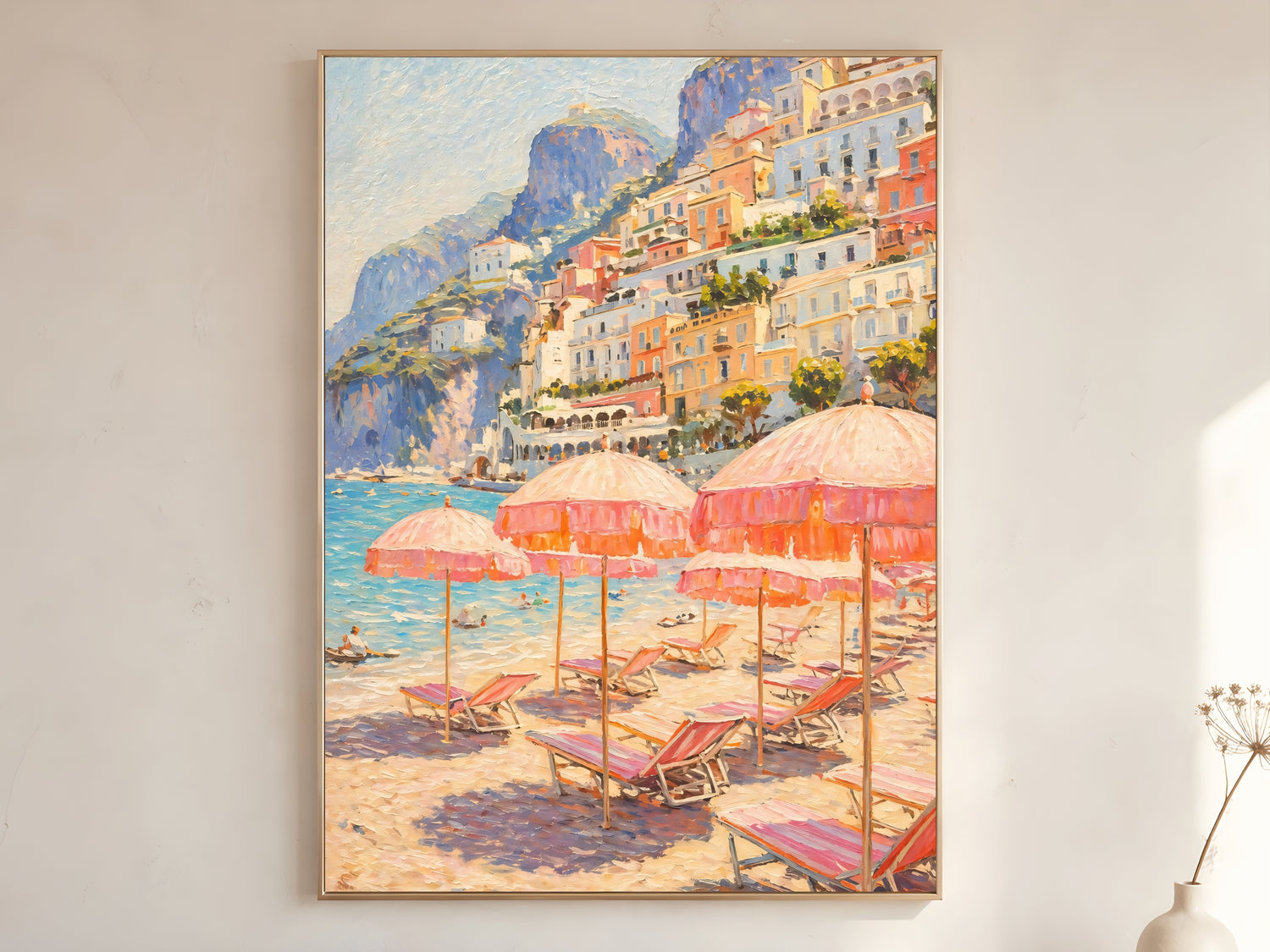 Positano beach club wall art print in gold frame displayed on warm white living room wall — impasto oil painting with pink parasols and Amalfi Coast hillside

