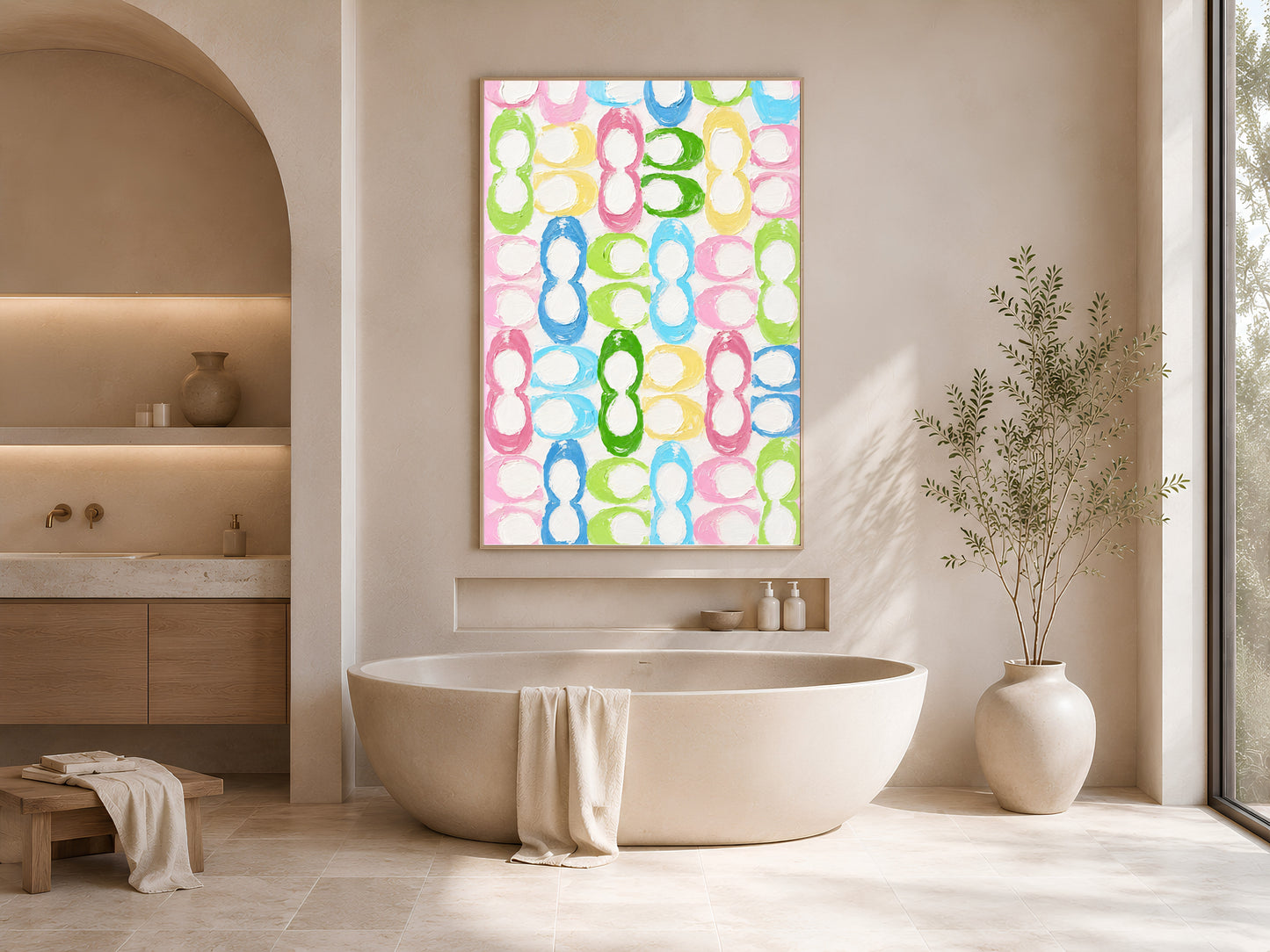 Colorful retro loop pattern print in gold frame beside freestanding bathtub in bright neutral bathroom with vase
