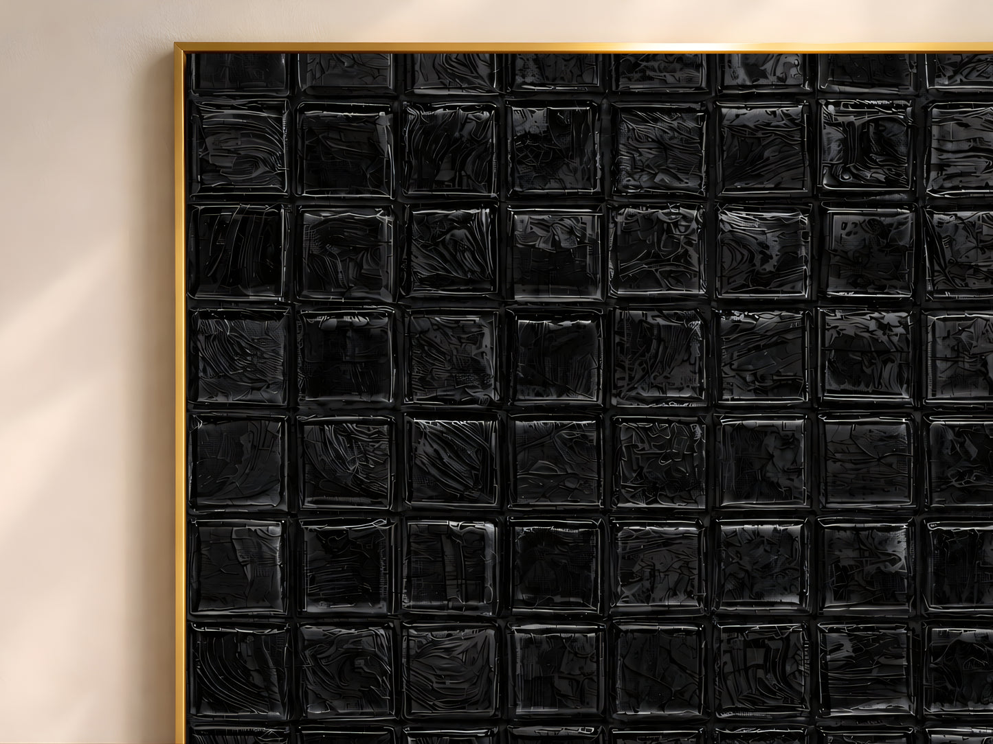 Close-up of black impasto mosaic tile wall art in a gold frame showing deep brushstroke texture detail on each tile square
