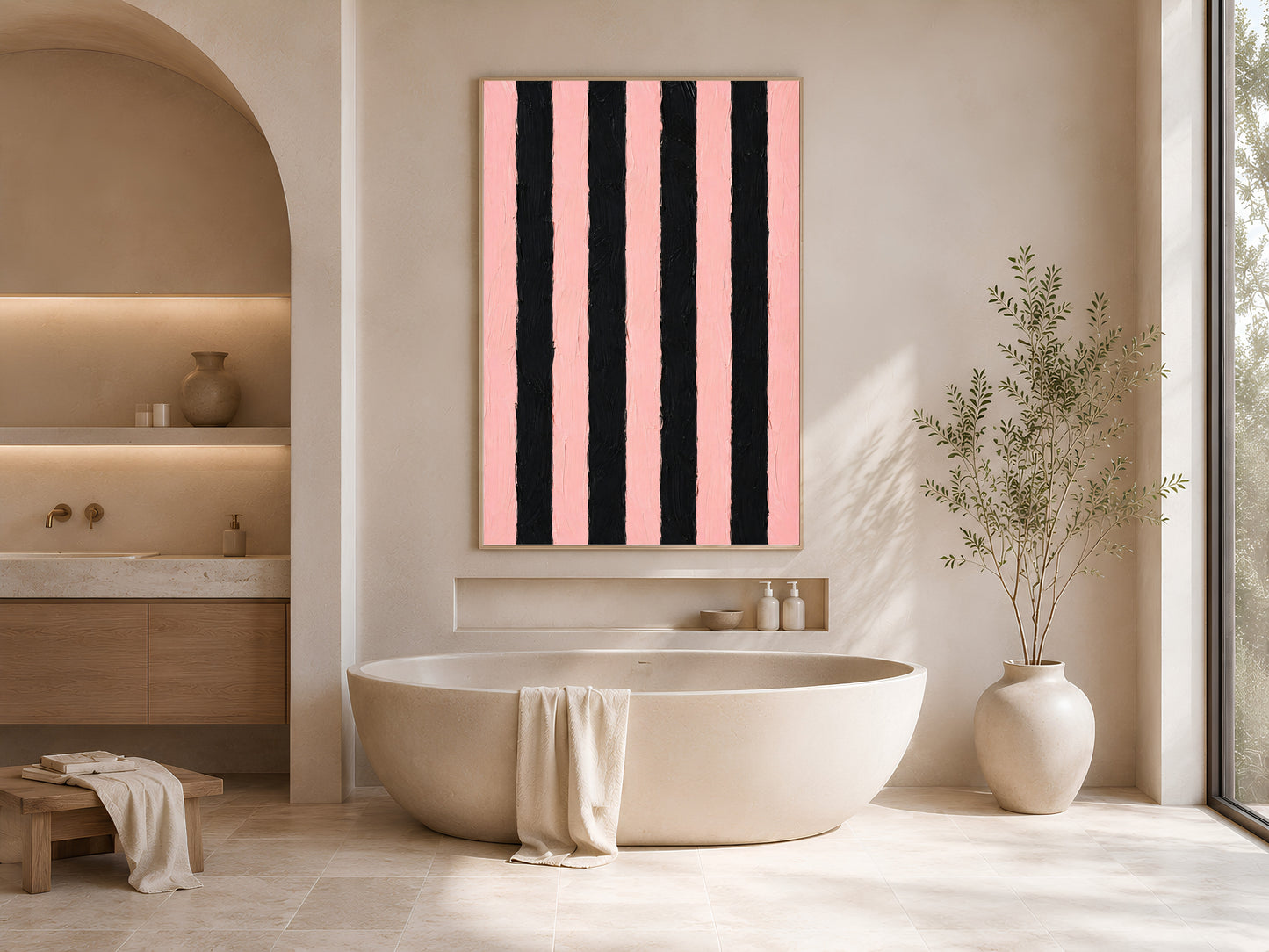 Bold pink and black stripe wall art in gold frame in bright bathroom beside freestanding bathtub with white vases

