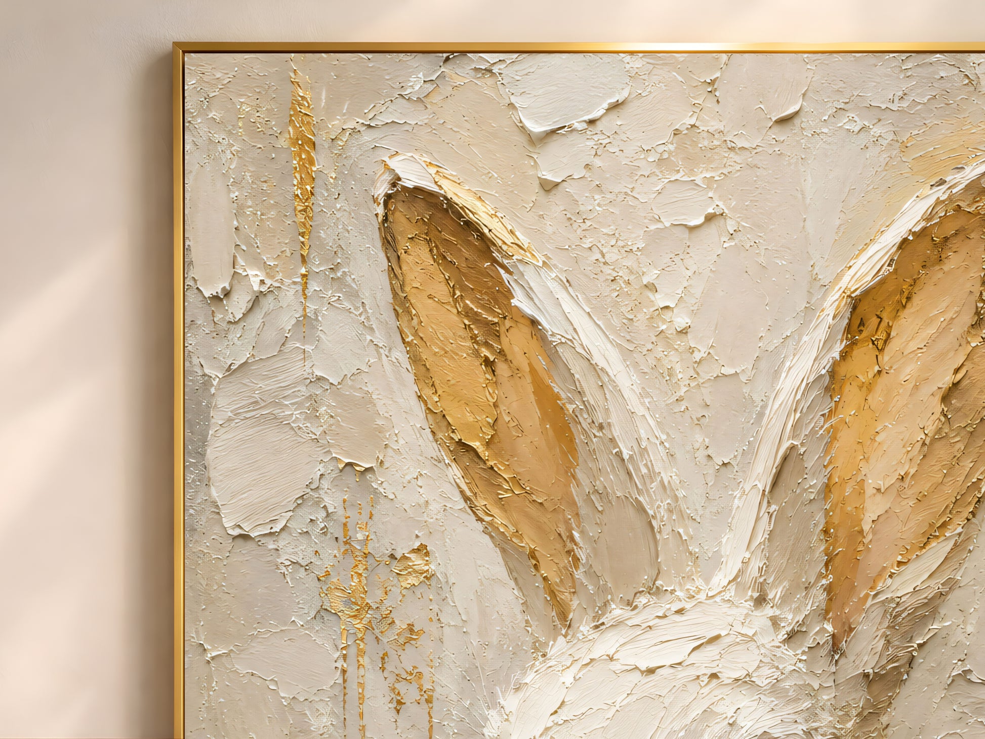 Close-up detail of white rabbit wall art in a gold frame showing thick impasto brushwork in cream, ivory, and warm gold leaf tones inside the rabbit's ears
