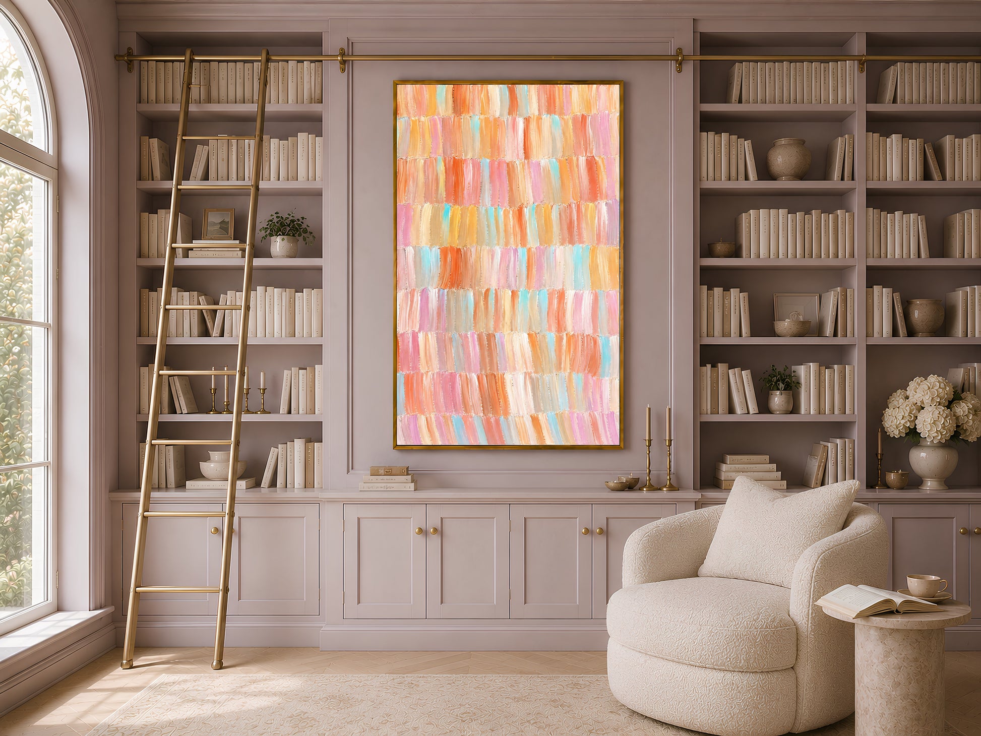 Framed colorful pastel impasto brushstroke art displayed in a warm library with tall built-in bookshelves and reading chair
