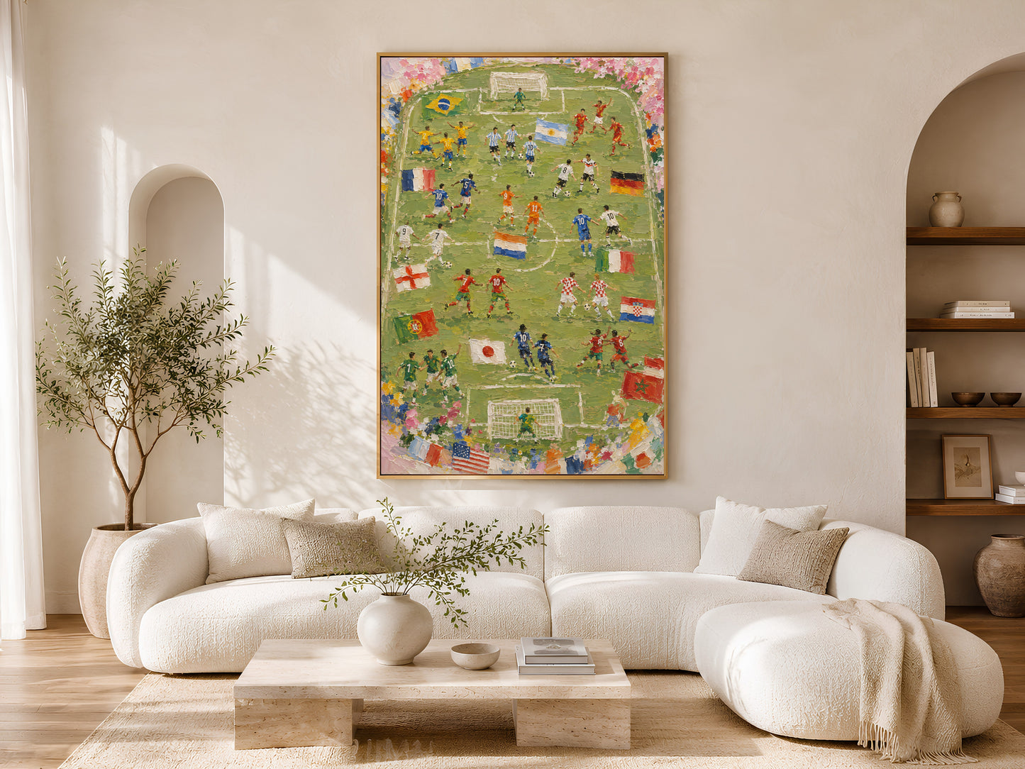 World Cup 2026 wall art in a wood frame styled above a cream curved sofa in a bright minimalist living room with warm wood floors and olive tree
