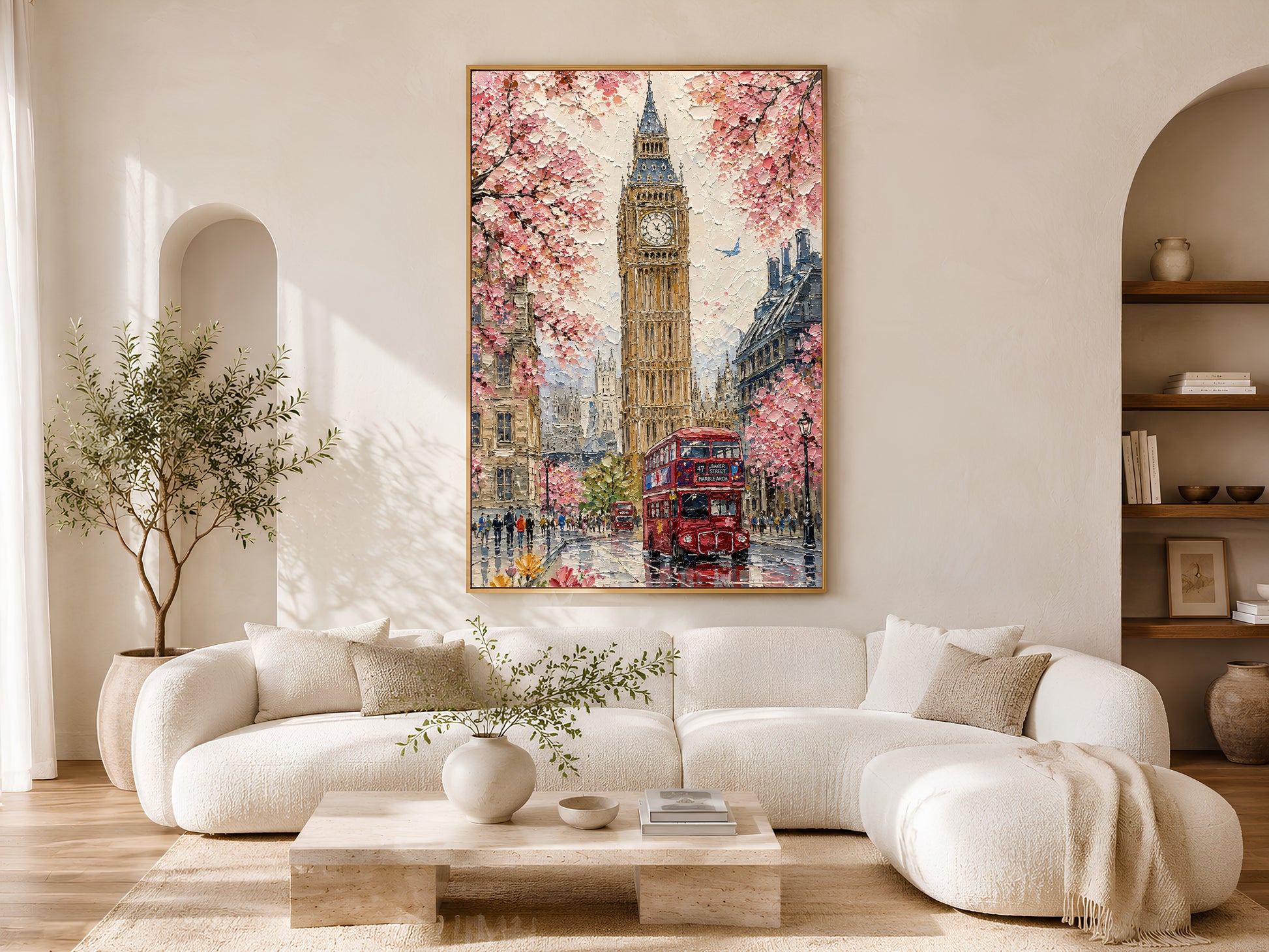London Big Ben cherry blossom impasto print in a wood frame styled above a cream curved sofa in a bright minimalist living room with warm wood floors and olive tree
