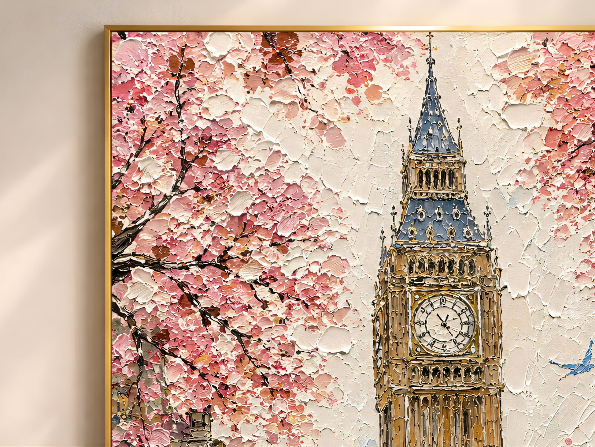 Close-up detail of London Big Ben impasto print in a gold frame showing thick painterly brushwork in blush pink cherry blossom, golden clock tower, red double-decker bus, and pale sky tones
