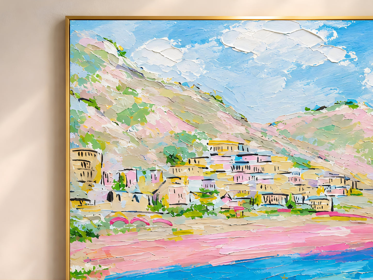 Close-up detail of Positano Amalfi Coast impasto print in a gold frame showing thick painterly brushwork in pink, turquoise, cobalt blue, lemon yellow, and warm sand tones
