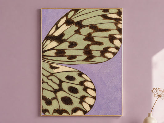 Framed lavender and sage green butterfly wing wall art print on a mauve accent wall