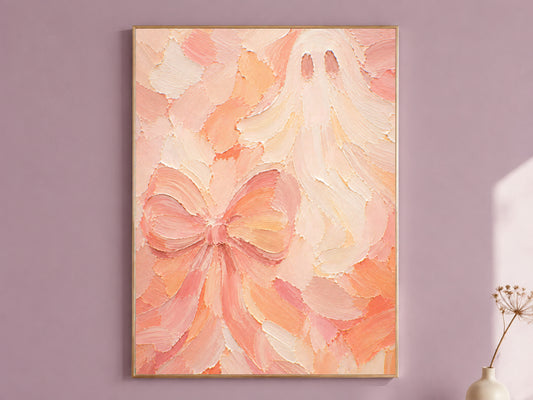 Framed pastel pink and peach impasto ghost and bow oil painting print hanging on a dusty mauve wall