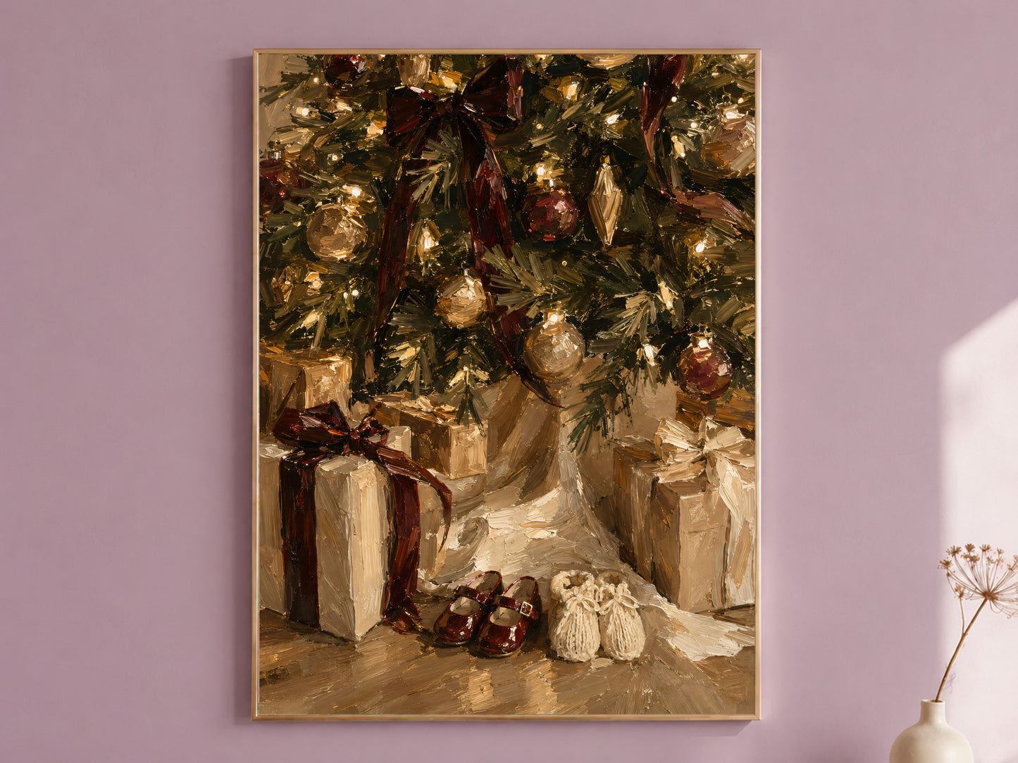 Christmas morning art print in a thin gold frame on a mauve wall, showing wrapped gifts and small shoes tucked under the tree, styled with a small vase of dried flowers