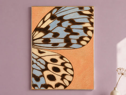 Framed terracotta and dusty blue butterfly wing wall art print on a mauve accent wall