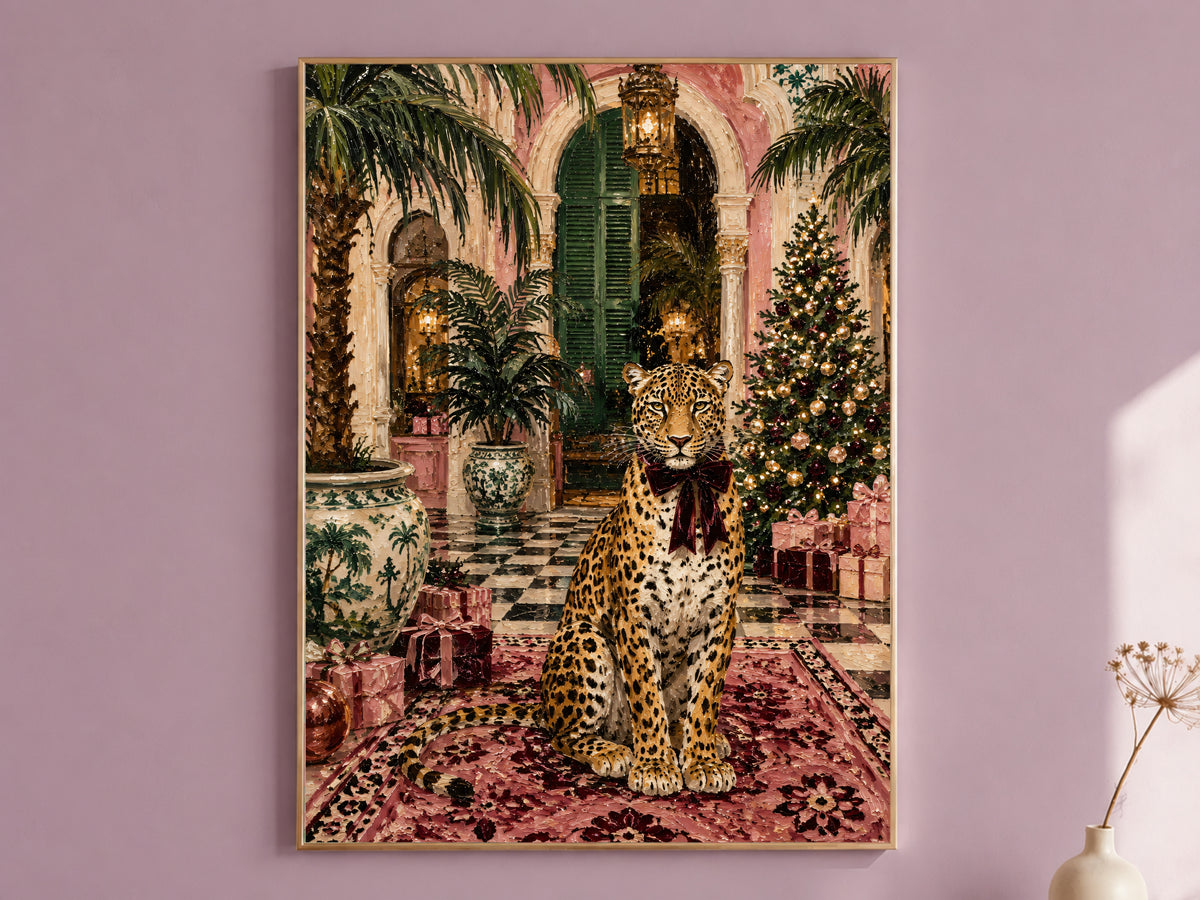 Leopard Christmas wall art print of a pink palazzo scene framed in gold, hung on a dusty mauve wall