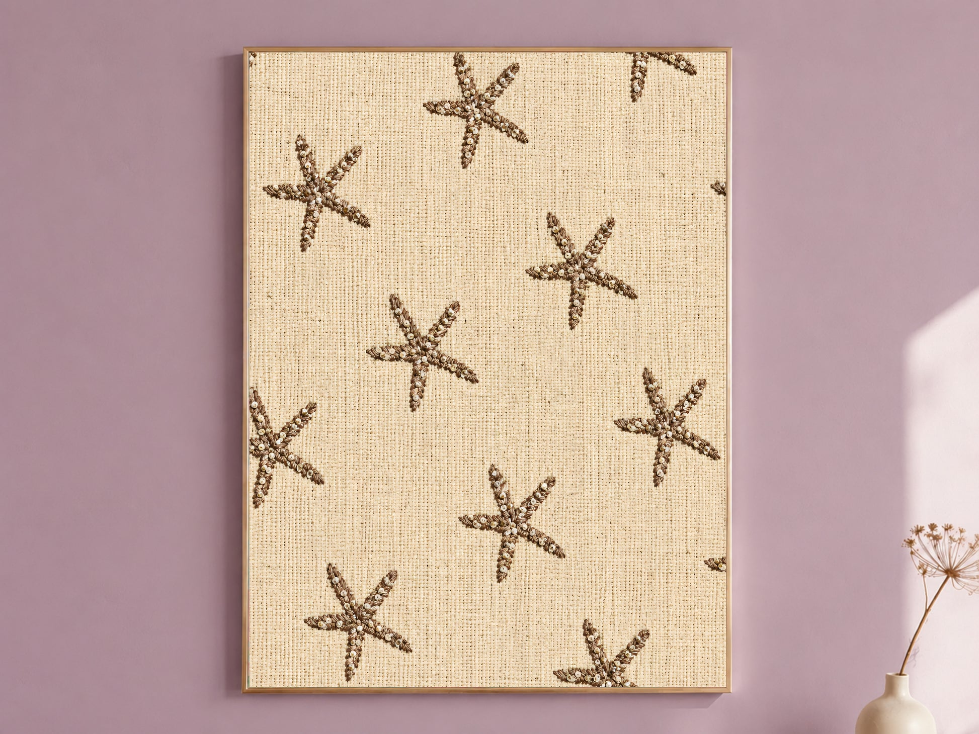 Framed embroidered starfish wall art on natural linen texture, styled on a dusty mauve wall