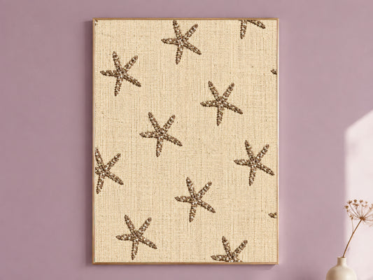 Framed embroidered starfish wall art on natural linen texture, styled on a dusty mauve wall