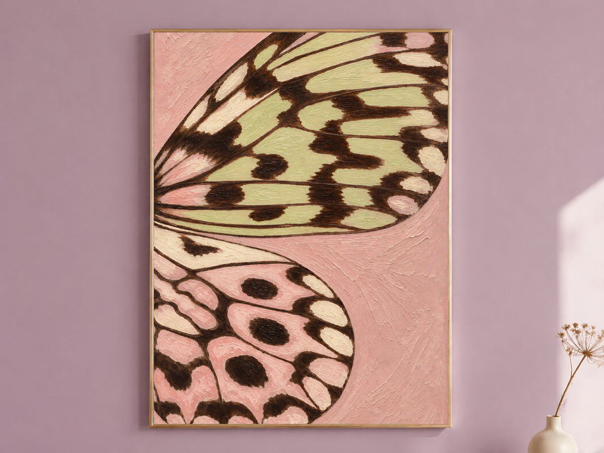 Framed butterfly wing wall art print in pink and sage green on a dusty mauve wall