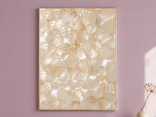 Mother of pearl mosaic wall art framed in gold, displayed on a dusty mauve wall with a dried flower stem