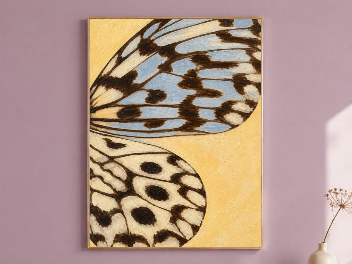 Framed butter yellow and dusty blue butterfly wing wall art print on a mauve accent wall