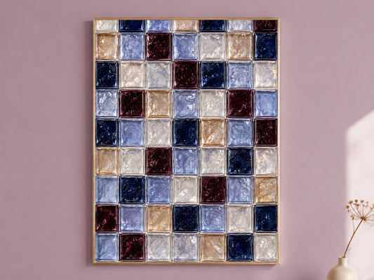 Navy and burgundy glass tile wall art in a gold frame on a mauve wall
