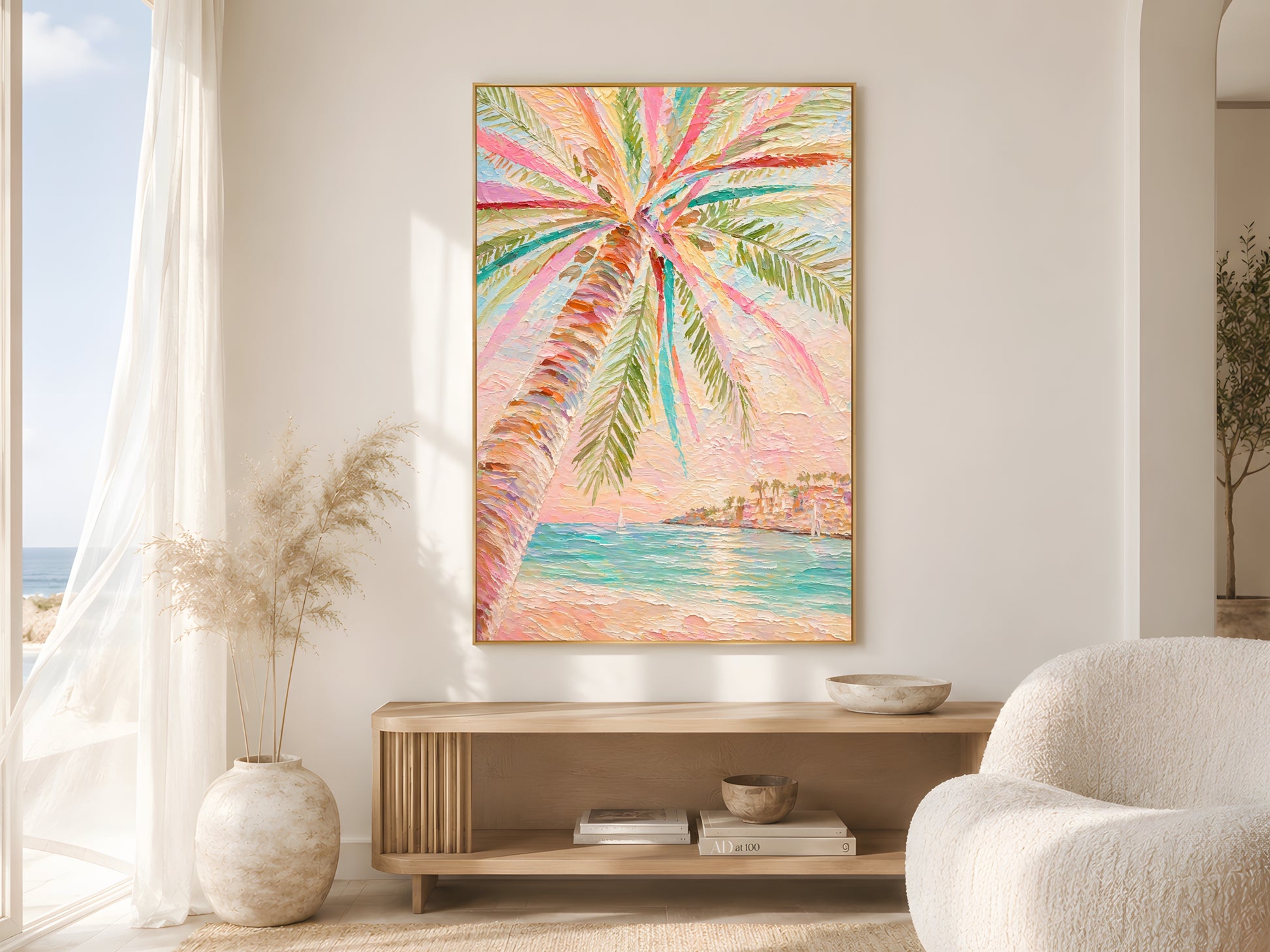 Colorful tropical palm tree impasto print in gold frame above wooden sideboard in warm minimalist living room with cream bouclé chair and dried botanicals
