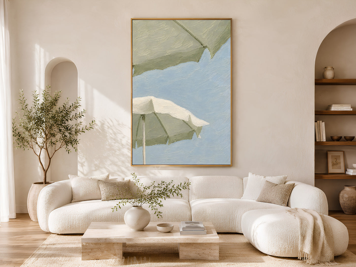 Sage green beach umbrella wall art in a wood frame styled in a bright Scandinavian living room with cream curved sofa, arched doorways, warm wood floors, and an olive tree
