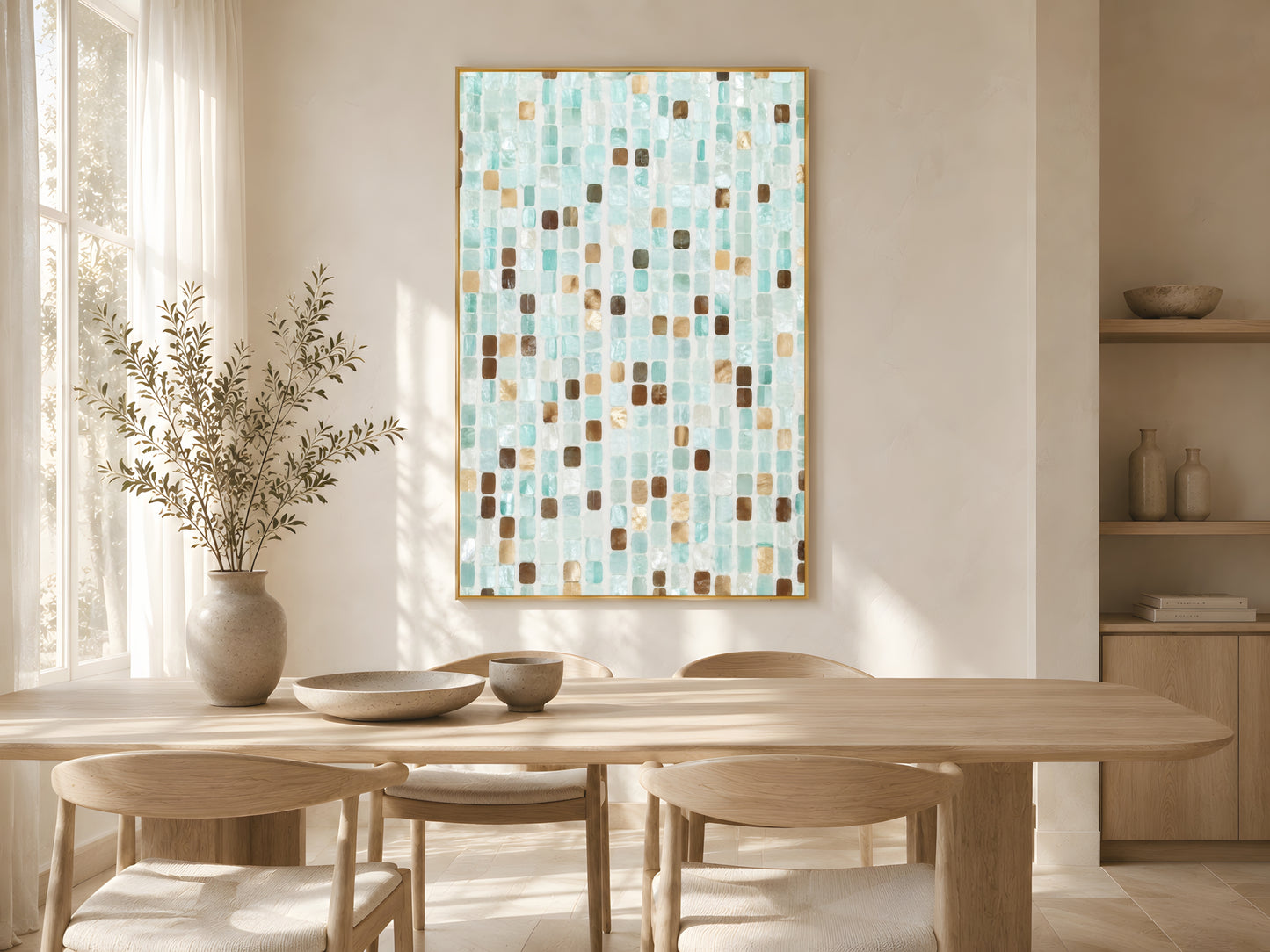 Teal mosaic tile print in gold frame above wooden dining table in warm minimalist Japandi dining room with cream chairs and soft natural light
