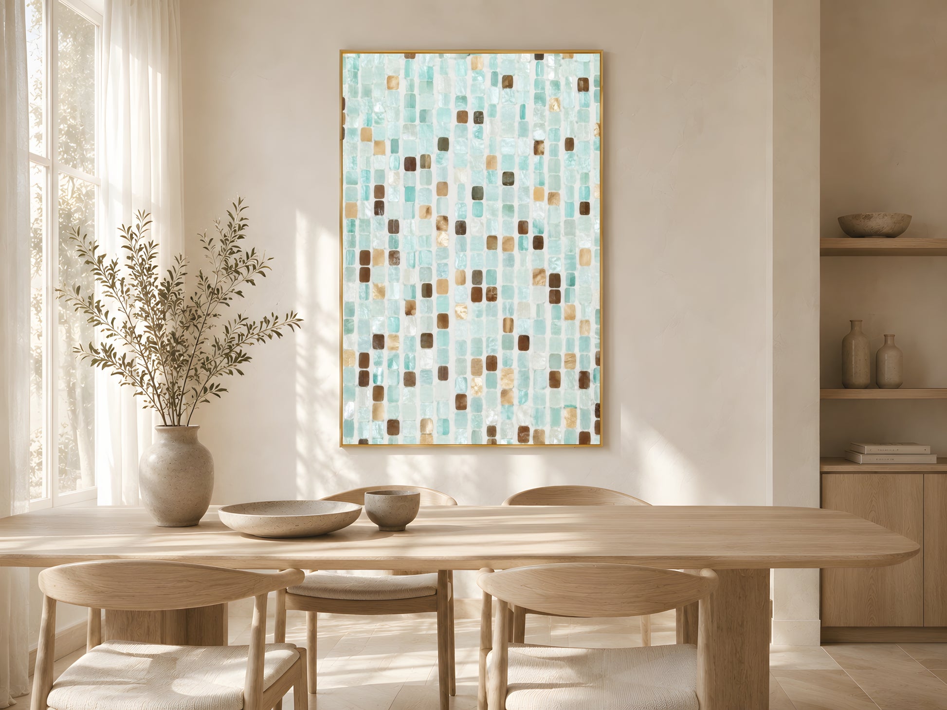 Teal mosaic tile print in gold frame above wooden dining table in warm minimalist Japandi dining room with cream chairs and soft natural light
